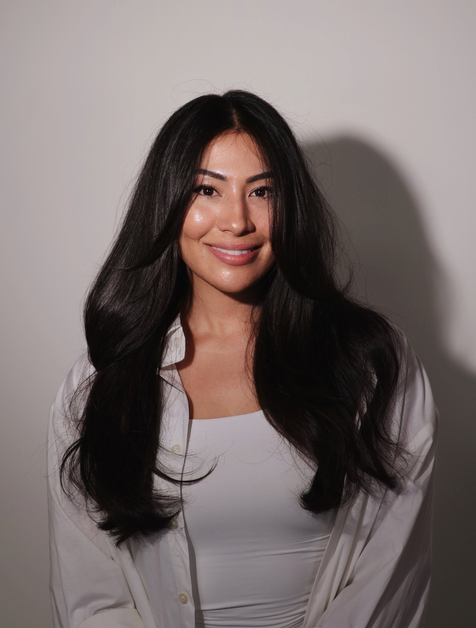 A woman with long black hair. Ghost layers. Long layers. Long hair cut. Asian hair.