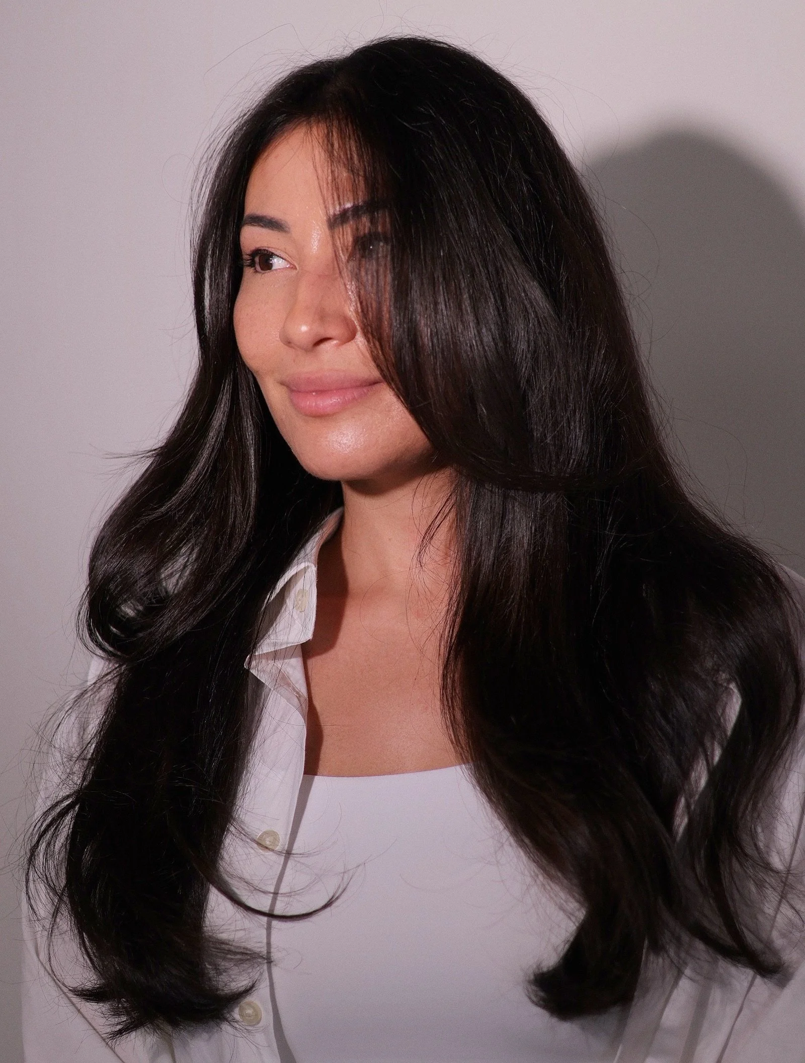 A woman with long, dark hair. Asian hair. Korean glass hair. 