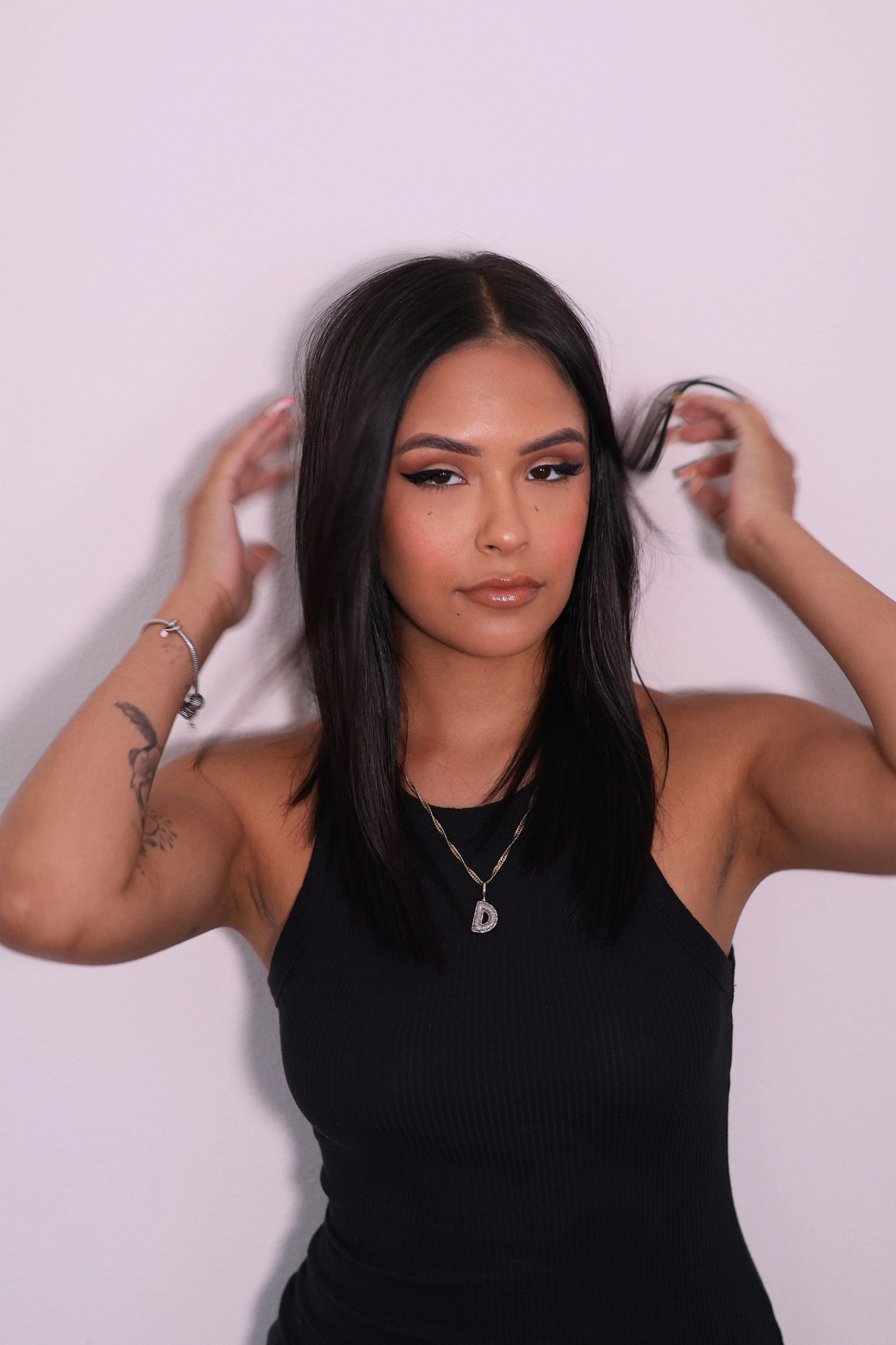 All-over espresso gloss. Middle-part straight hair. Face framing layers.