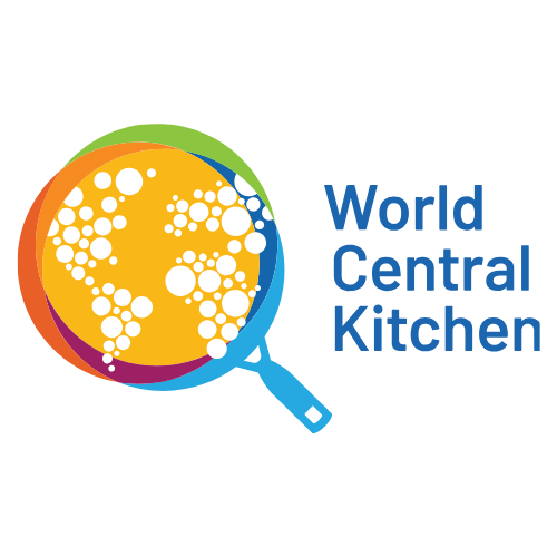 Logo with a magnifying glass over a world map made of white dots, and the text 'World Central Kitchen' in blue to the right.