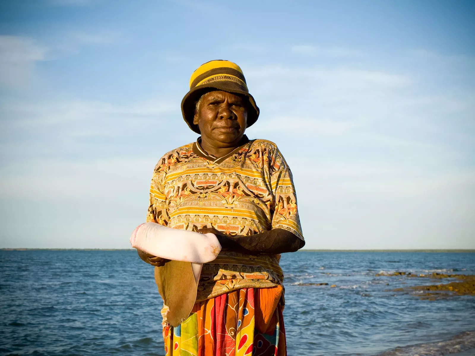 Claire-Bawudba-preparing-sting-ray-wing-for-cooking.webp