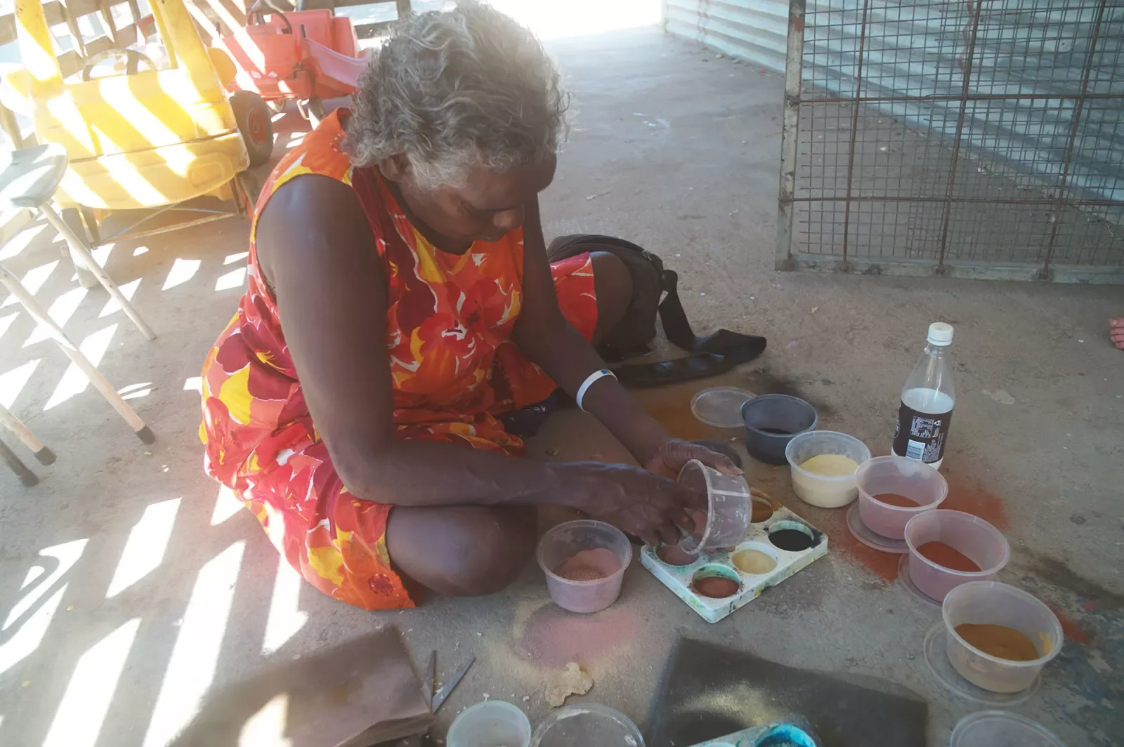 Shirley-Drill-mixing-traditional-ochres-for-painting-Frog-Hollow-Kimberley-WA.webp