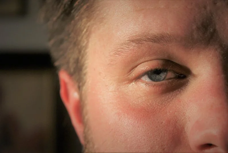 Close-up of a man's face, showing his eye and part of his forehead and cheek.