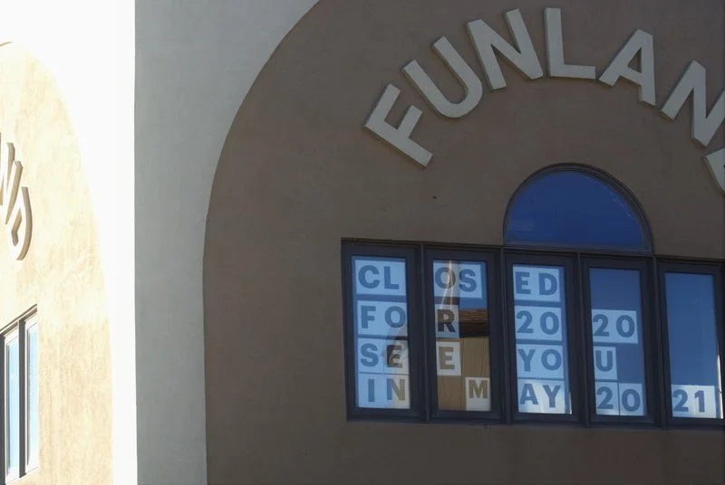 The windows display messages that spell out 'CLOSED FOR REMAY 2021' with some letters missing or obscured, and the building has a sign that reads 'FUNLAND' at the top.