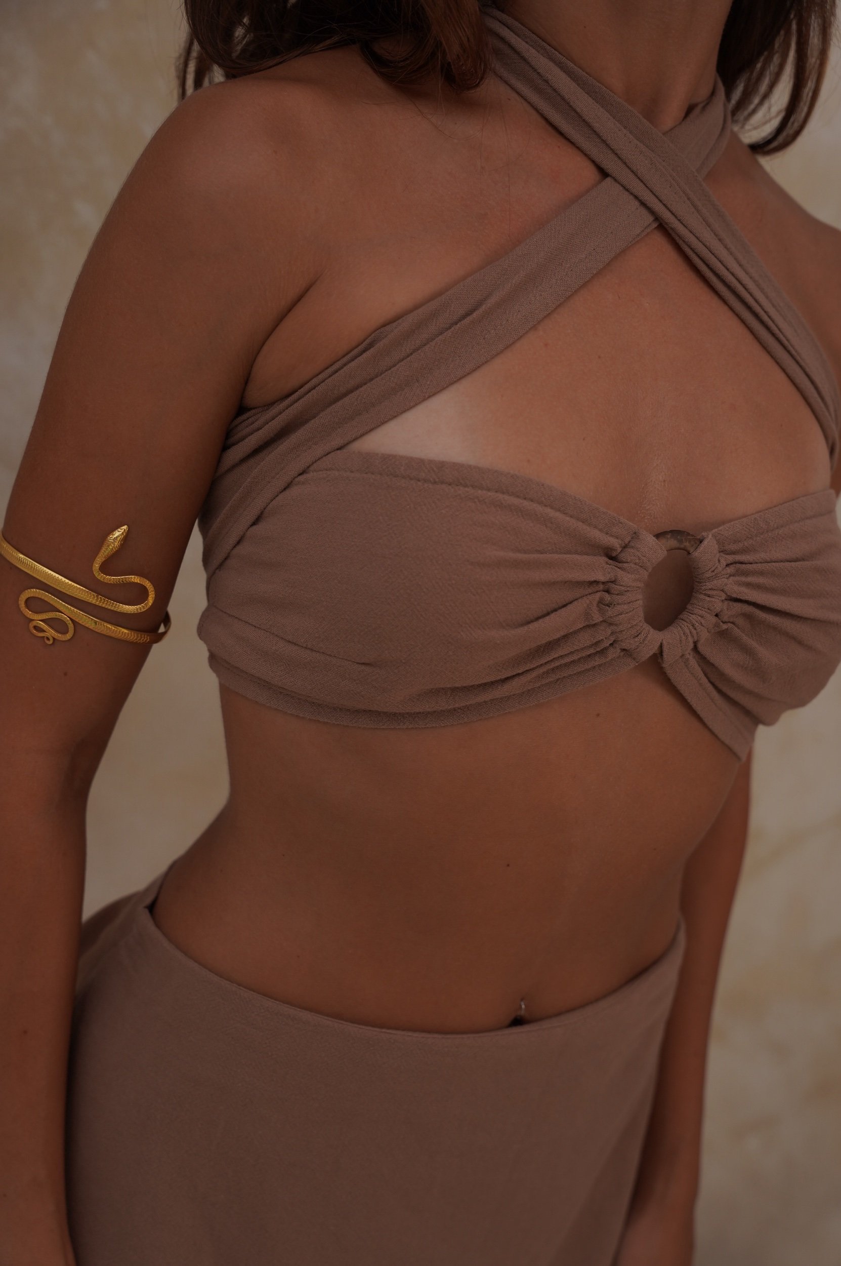 Woman in Inanna Wrap Top standing barefoot at a retreat, wrapped close at the waist, soft natural light