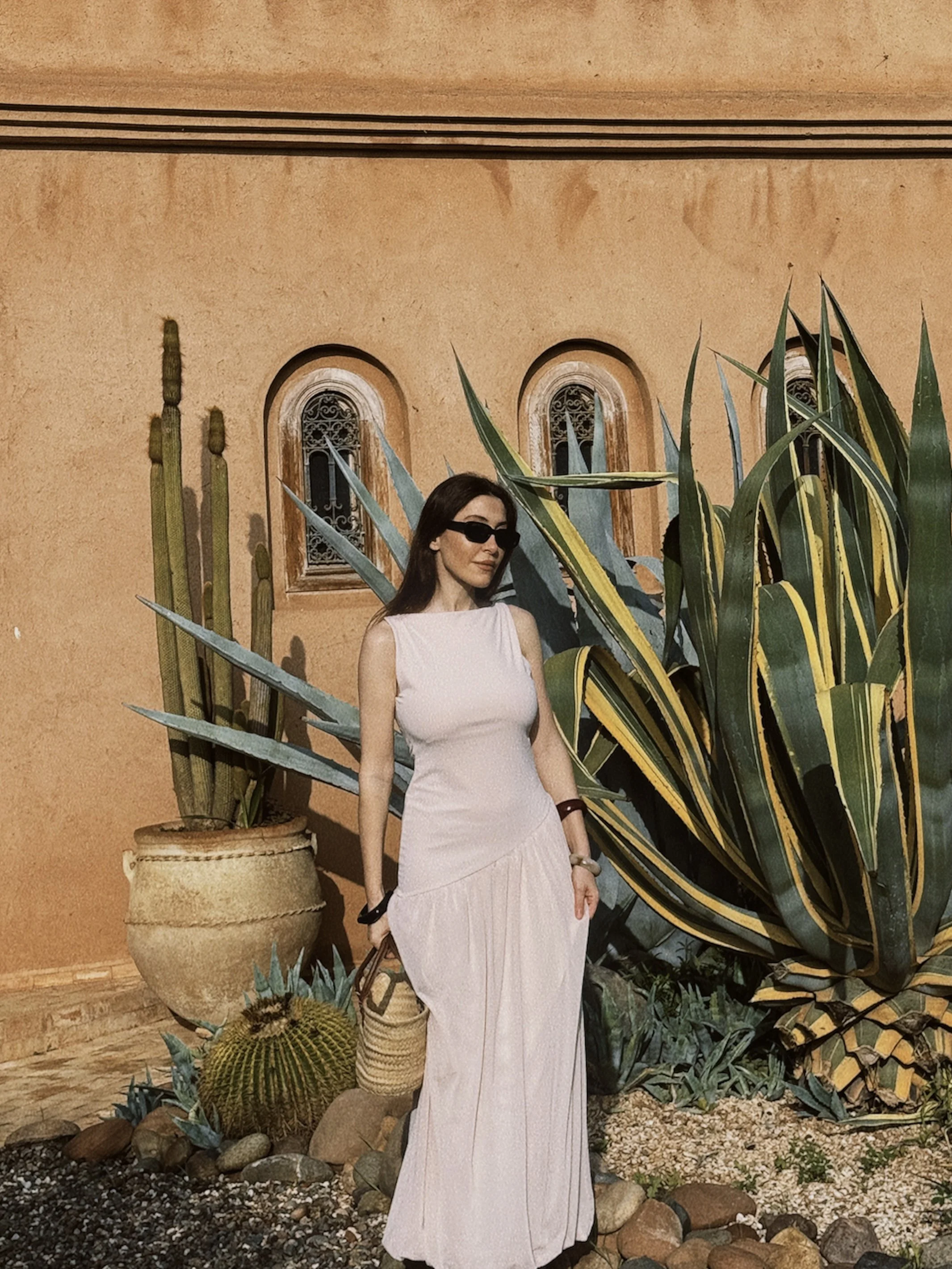 Woman standing in front of Moroccan villa representing getting your spark back after functional freeze