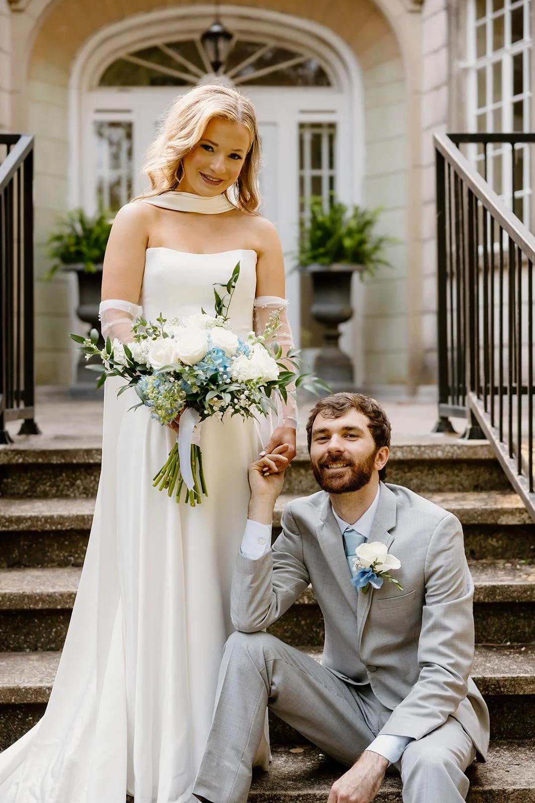 Bride and groom on the steps of the historic mansion at Burritt on the Mountain