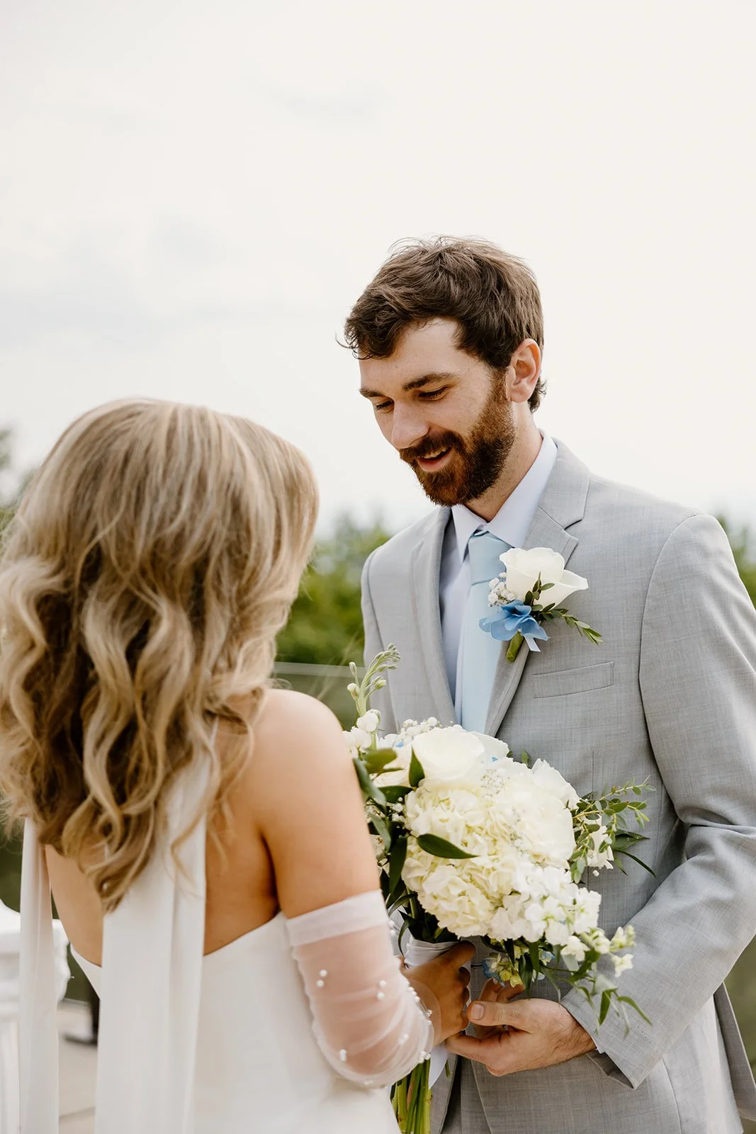 Groom smiling at his bride during their first look
