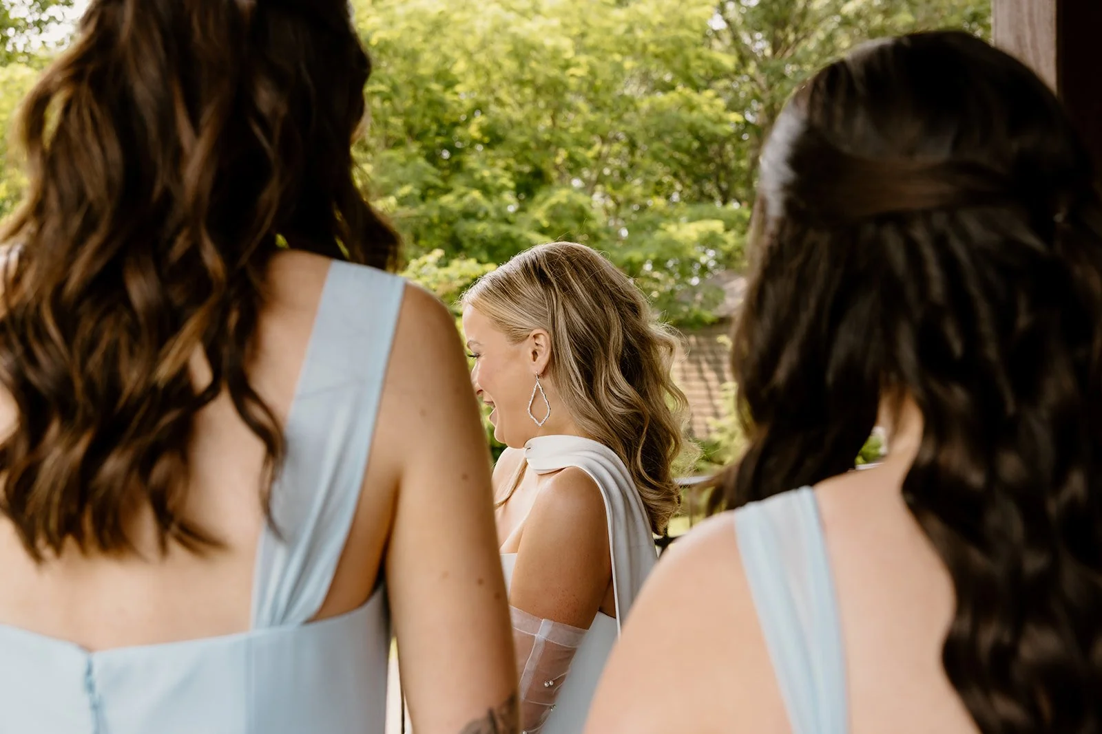 Bridesmaids reacting during their first look with the bride