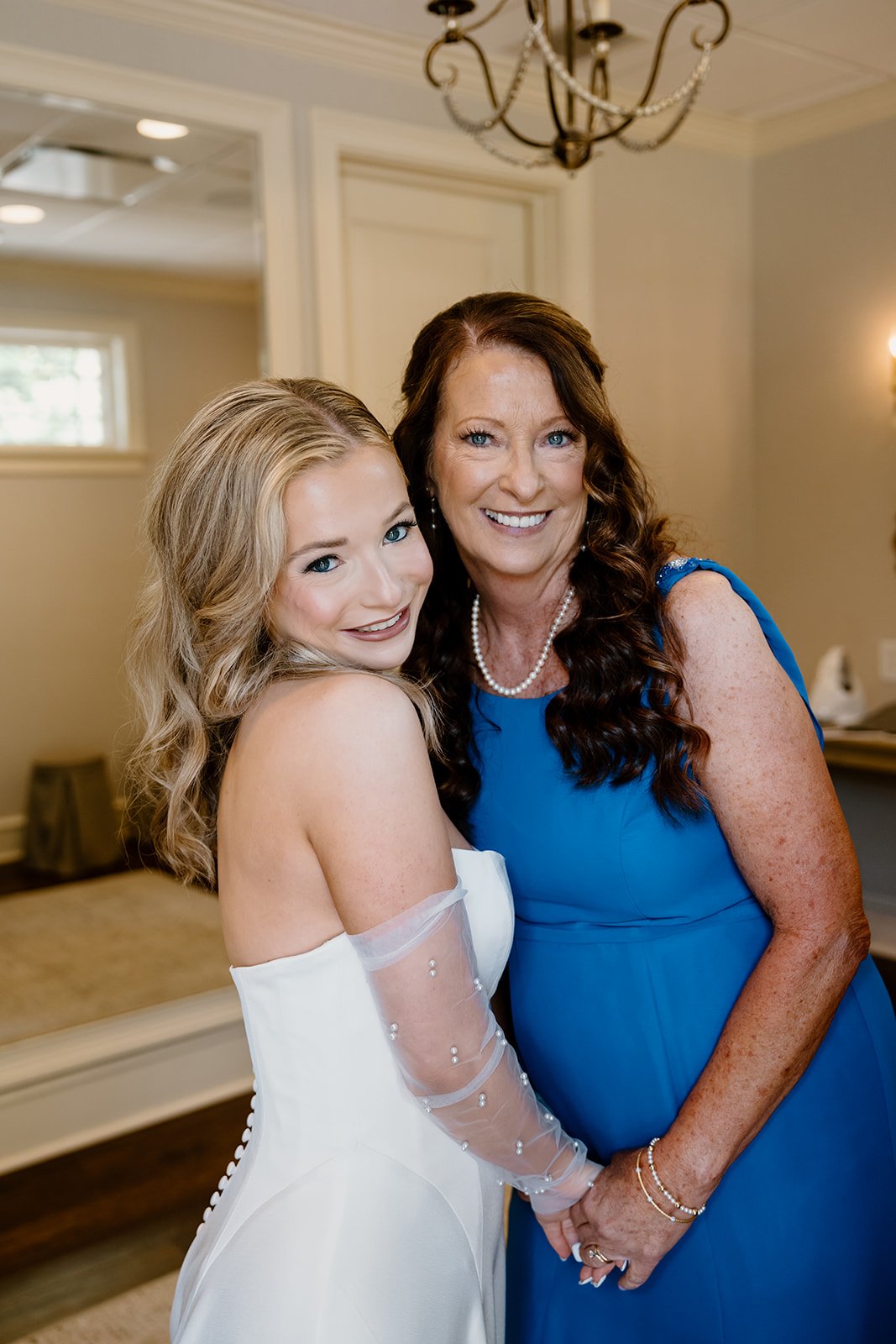 Bride hugging her mom after getting dressed on her wedding day