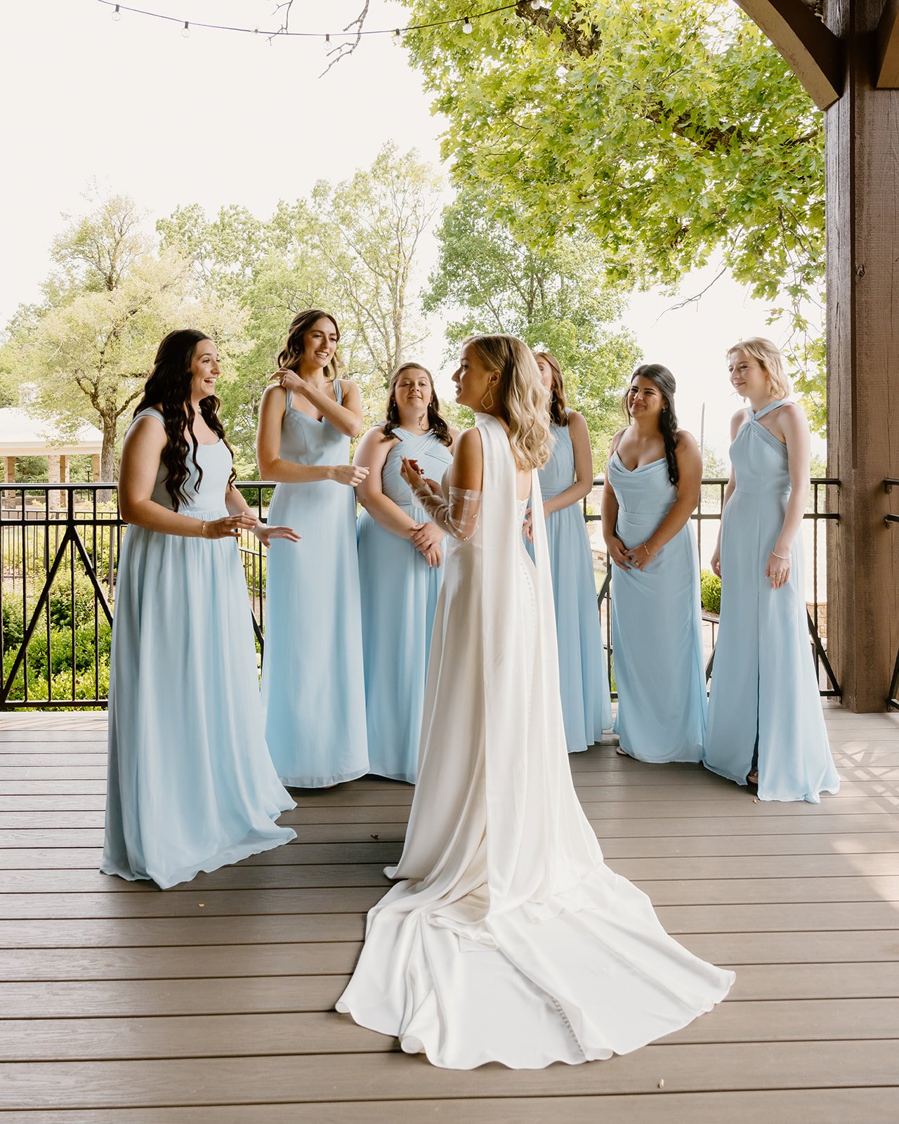 Bridesmaids in sky blue seeing the bride for the first time at Burritt on the Mountain
