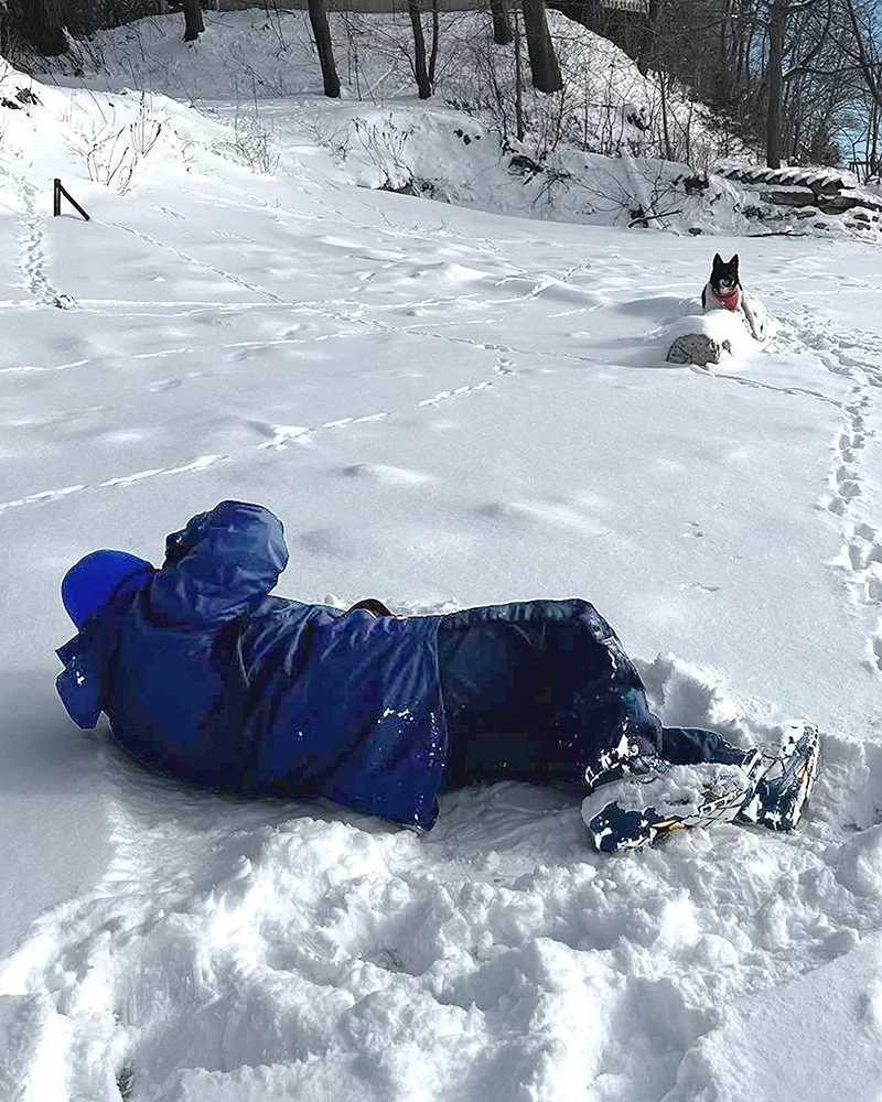 photographer lying in the snow for a portrait
