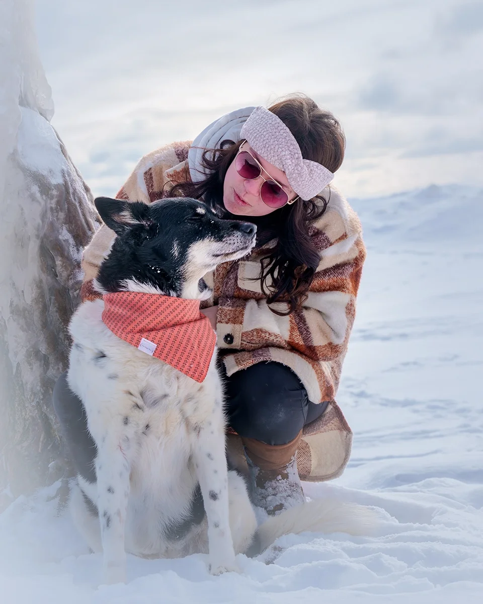 owner and her dog by a tree on a snow covered beach on lake erie