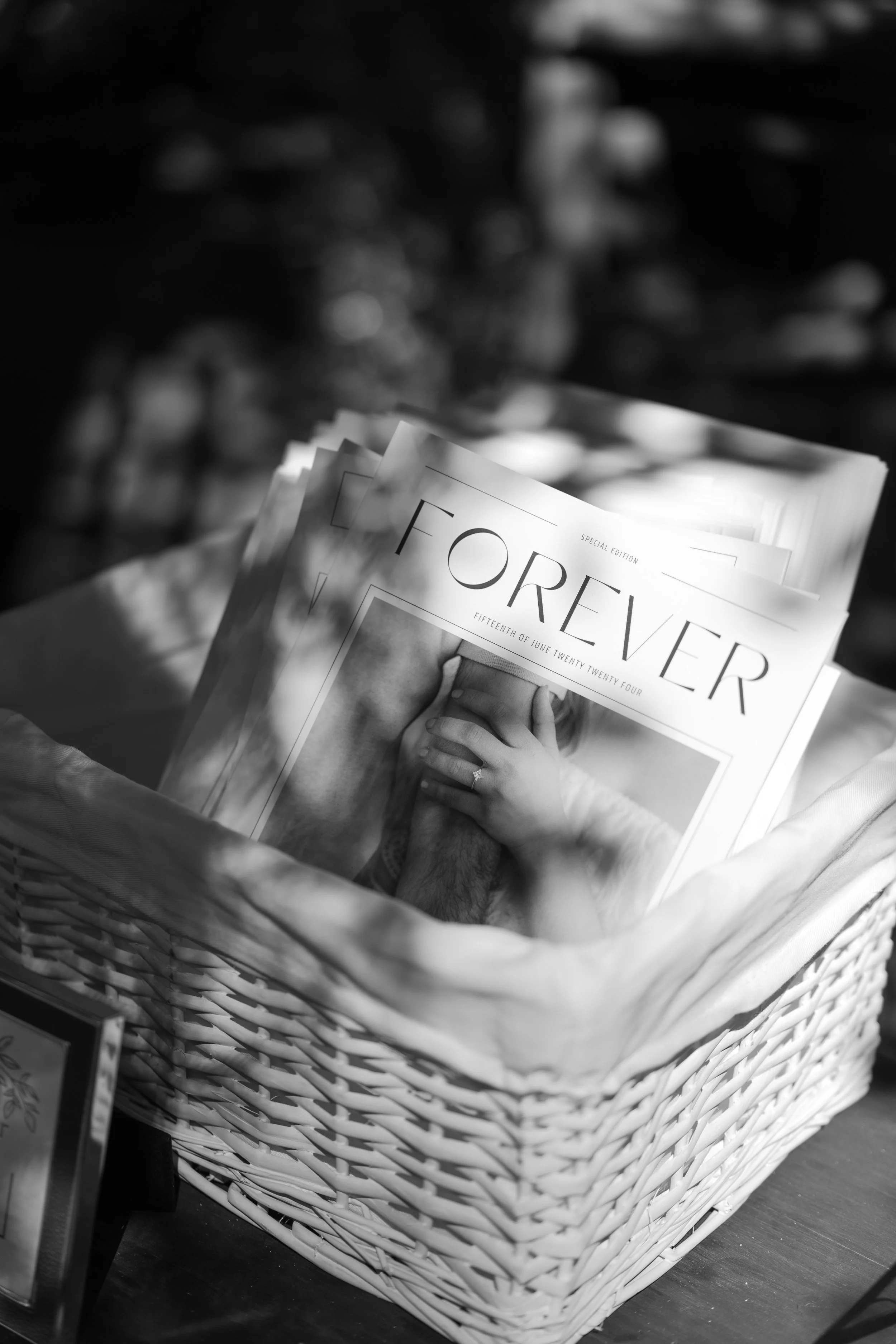 A magazine titled 'Forever' with a wedding photograph on the cover, placed inside a woven basket.