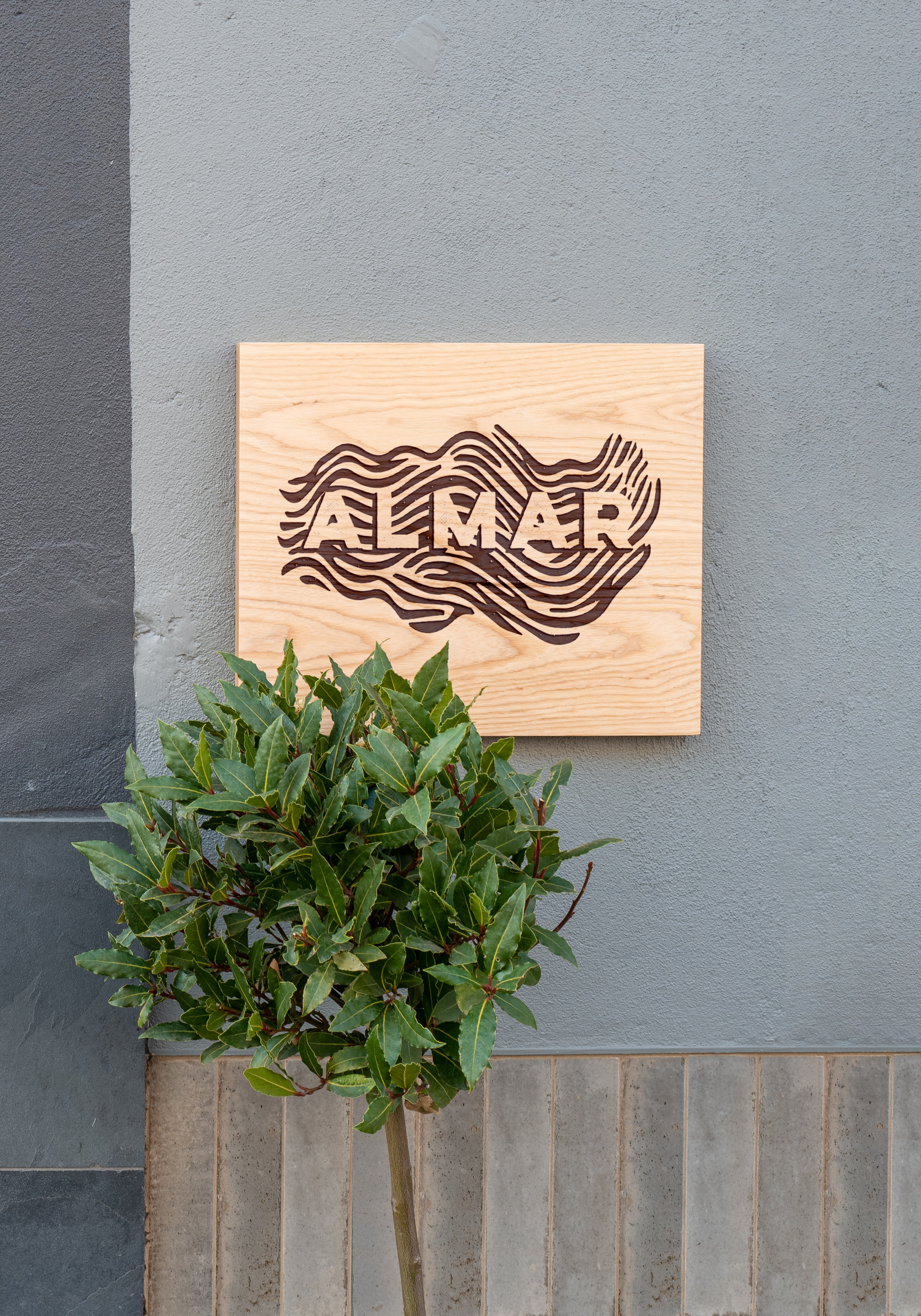 Wood Sign on Wall PSD Mockup.png