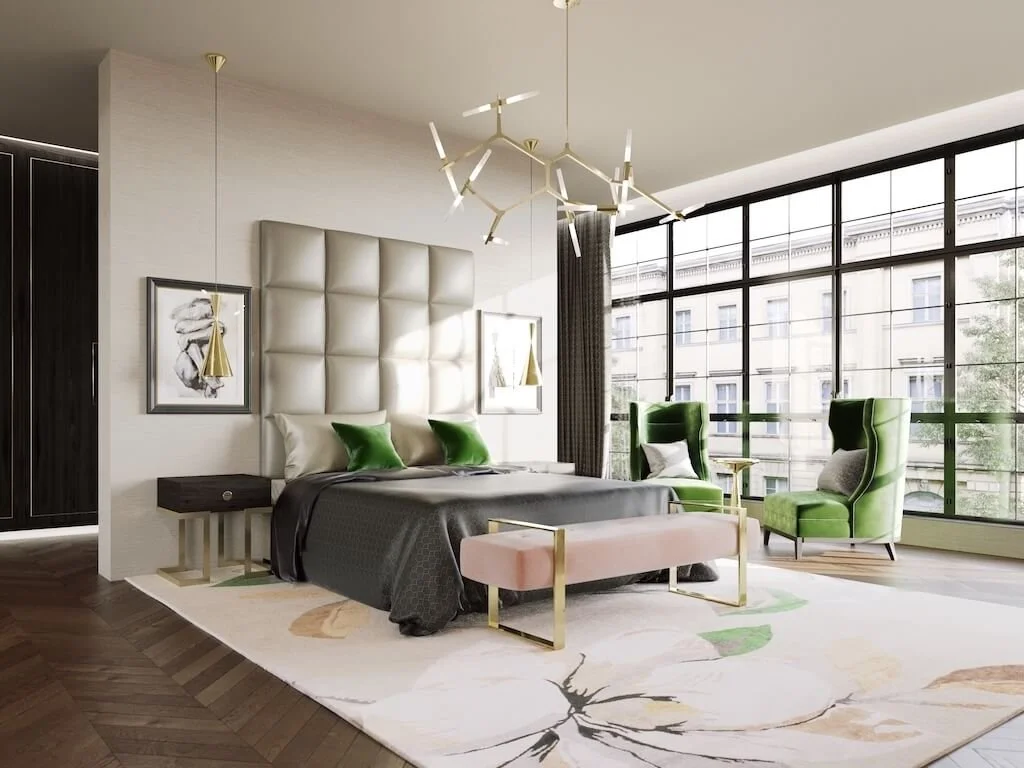 Modern-classic Mayfair bedroom by Jo Hamilton Interiors: padded headboard, brass chandelier, green velvet chairs, blush bench and steel-framed windows across central London.