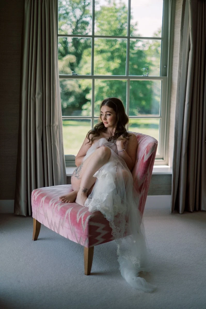  Bride smiling during her bridal boudoir experience in Hampshire ahead of her wedding in Thailand. 