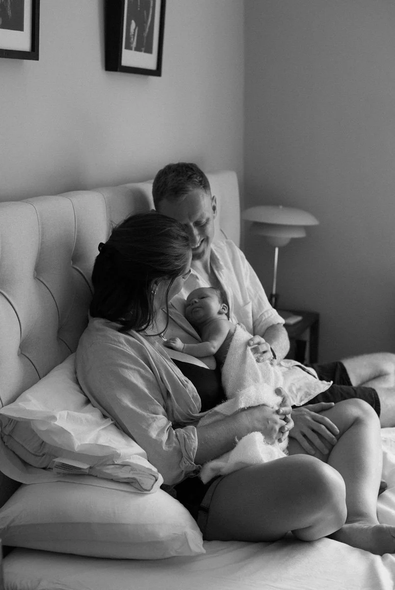  Lifestyle newborn photography session at home in Southsea with parents cuddling their newborn baby. 