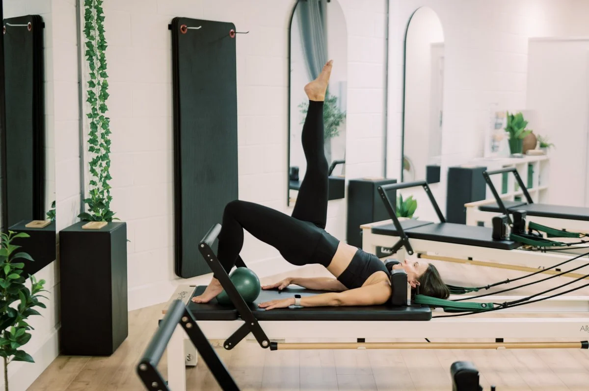 Natural portrait of a Pilates instructor photographed inside her Hampshire studio
