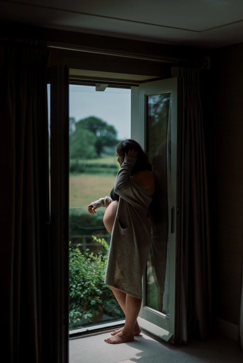 Luxury maternity photography session capturing a mother-to-be in a calm and elegant setting.