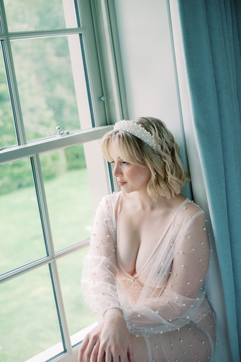 bride to be sat in window