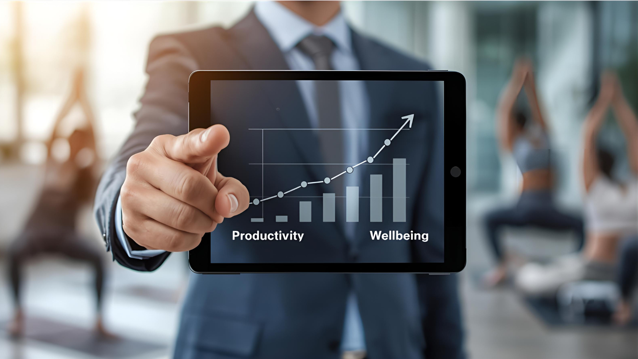 Geschäftsmann hält ein Tablet mit einer Grafik zu Produktivitäts- und Wohlbefindens-Steigerungen, mit Yoga im Hintergrund.