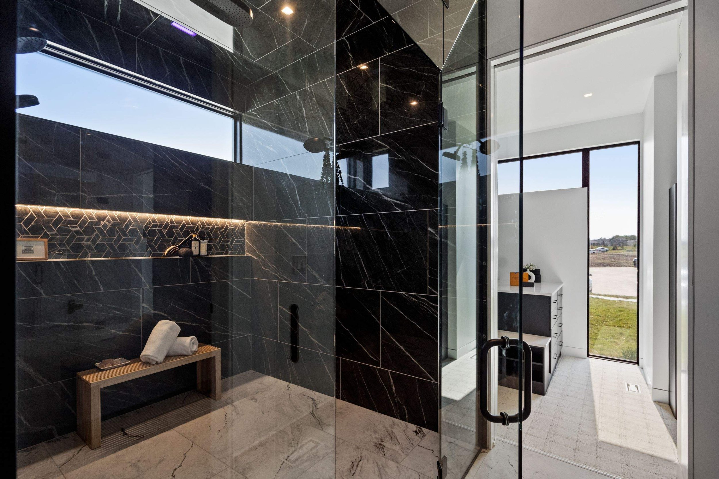 Custom LED lighting installations highlight the geometric tile design, creating a serene spa-like atmosphere. Perfectly integrated low-voltage systems ensure seamless functionality.