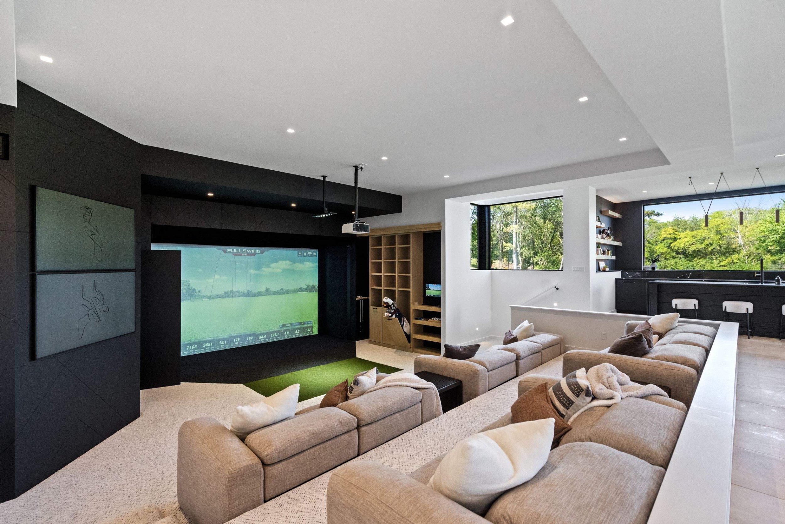State-of-the-art low-voltage setups power the immersive home theater and golf simulator, delivering high-performance entertainment at home.