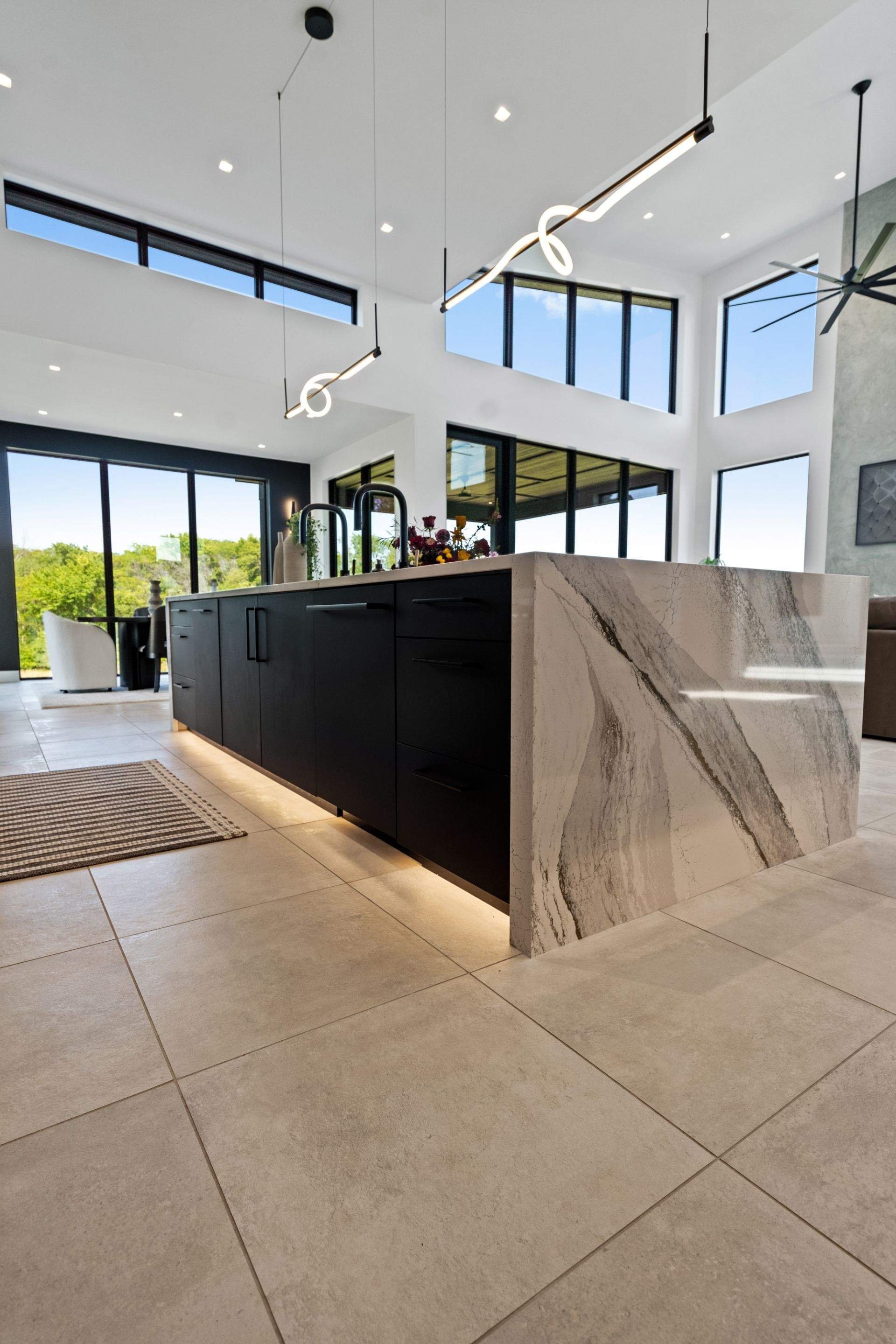 A striking modern kitchen outfitted with advanced low-voltage lighting systems and trimless recessed fixtures, enhancing clean lines and a sophisticated ambiance.