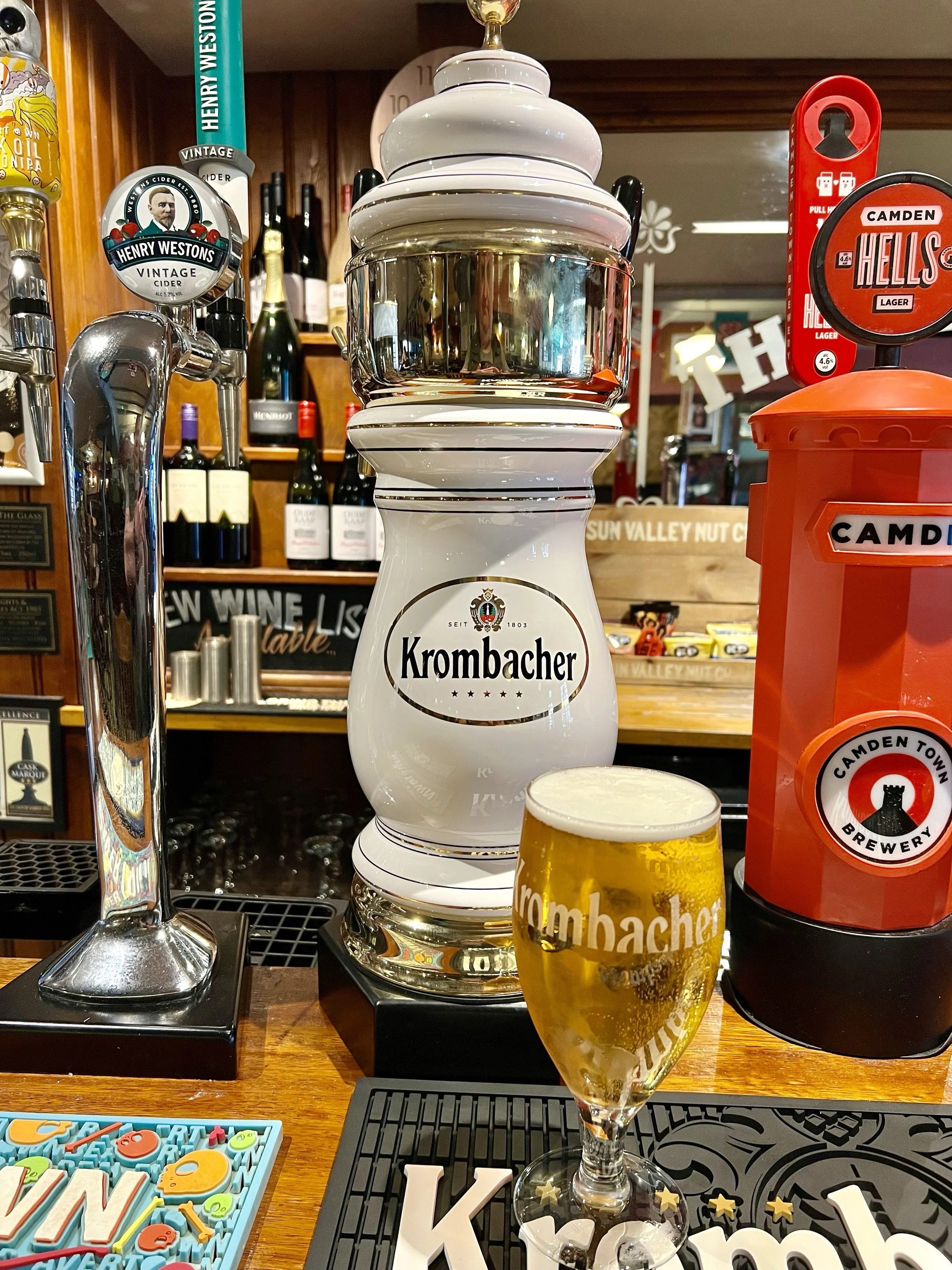 A Pint of Krombacher Pils in front of it's Tap