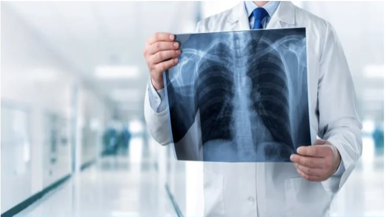 A doctor in a white coat reviews an x-ray of a nursing home patient that was injured.