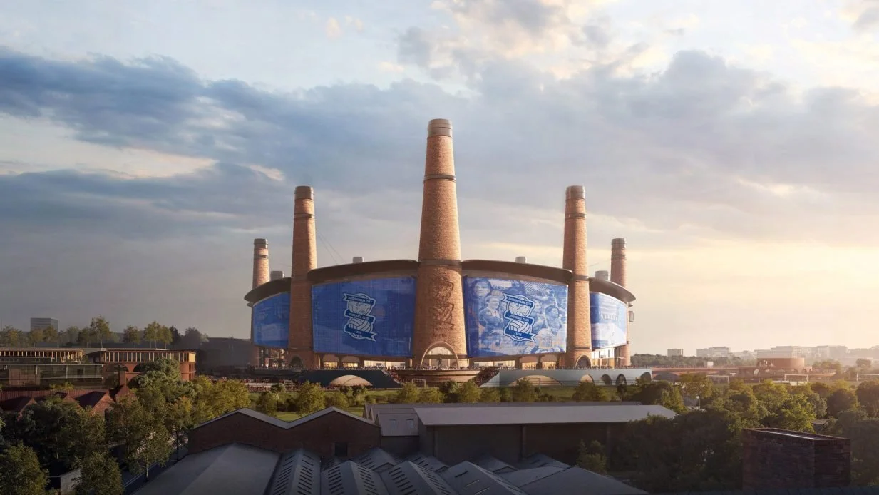 A sports stadium with decorative smokestacks integrated into its design.