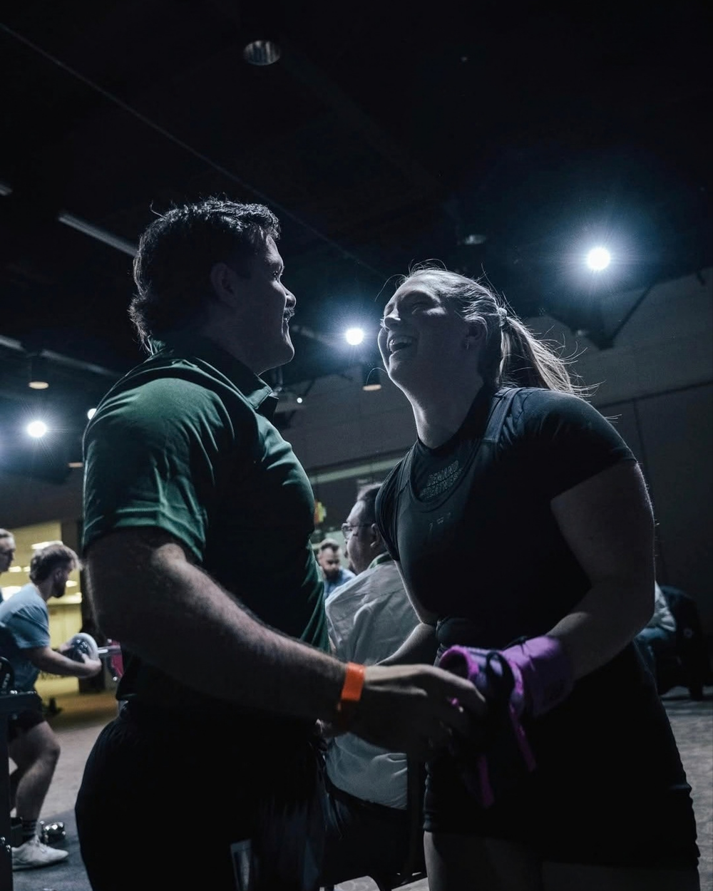 A BCB coach talking with an athlete at a meet