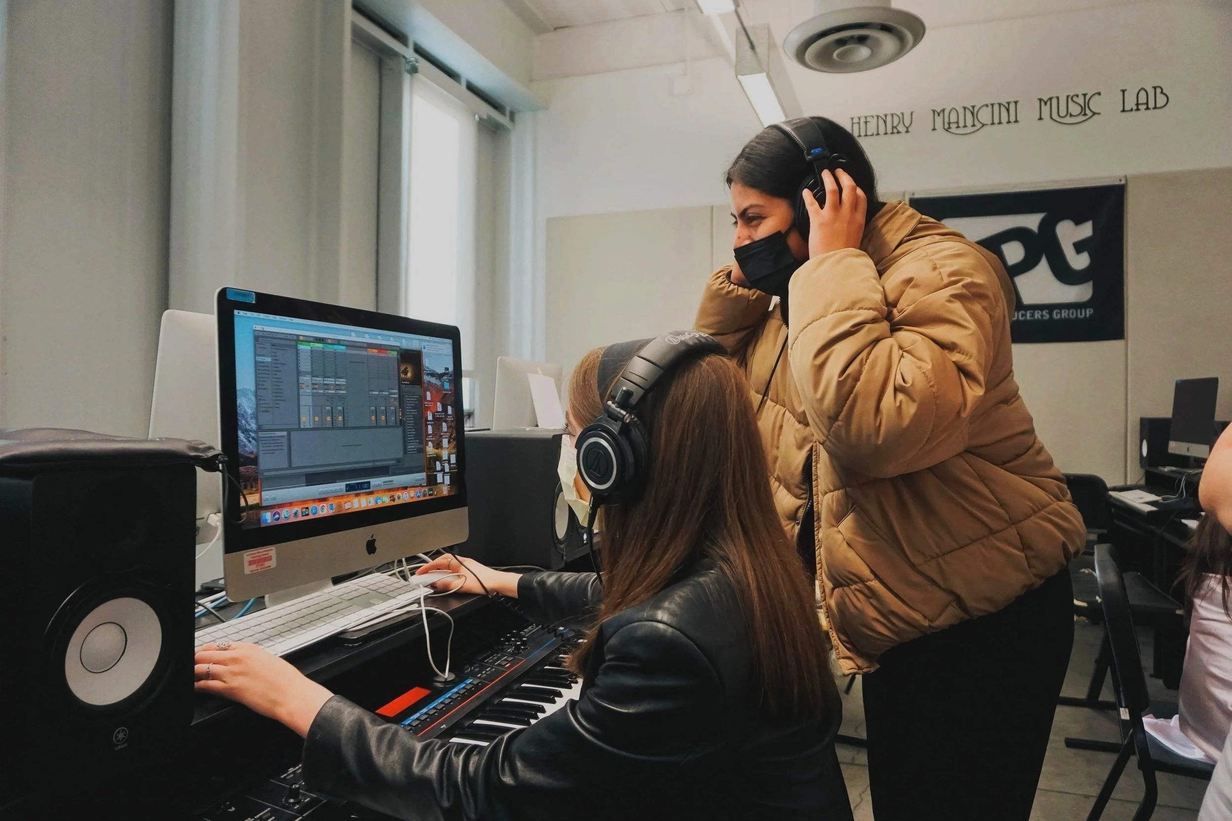 Two YPG students collaborate on Ableton Live during a music production class.