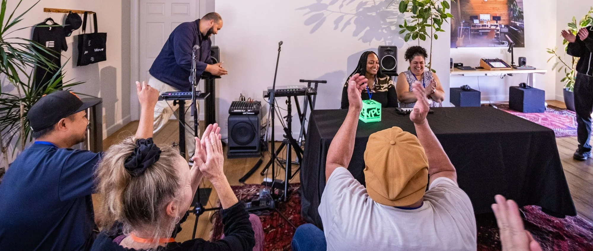 Two teachers perform their original track on Ableton Move at Ableton Spaces while other teachers applaud