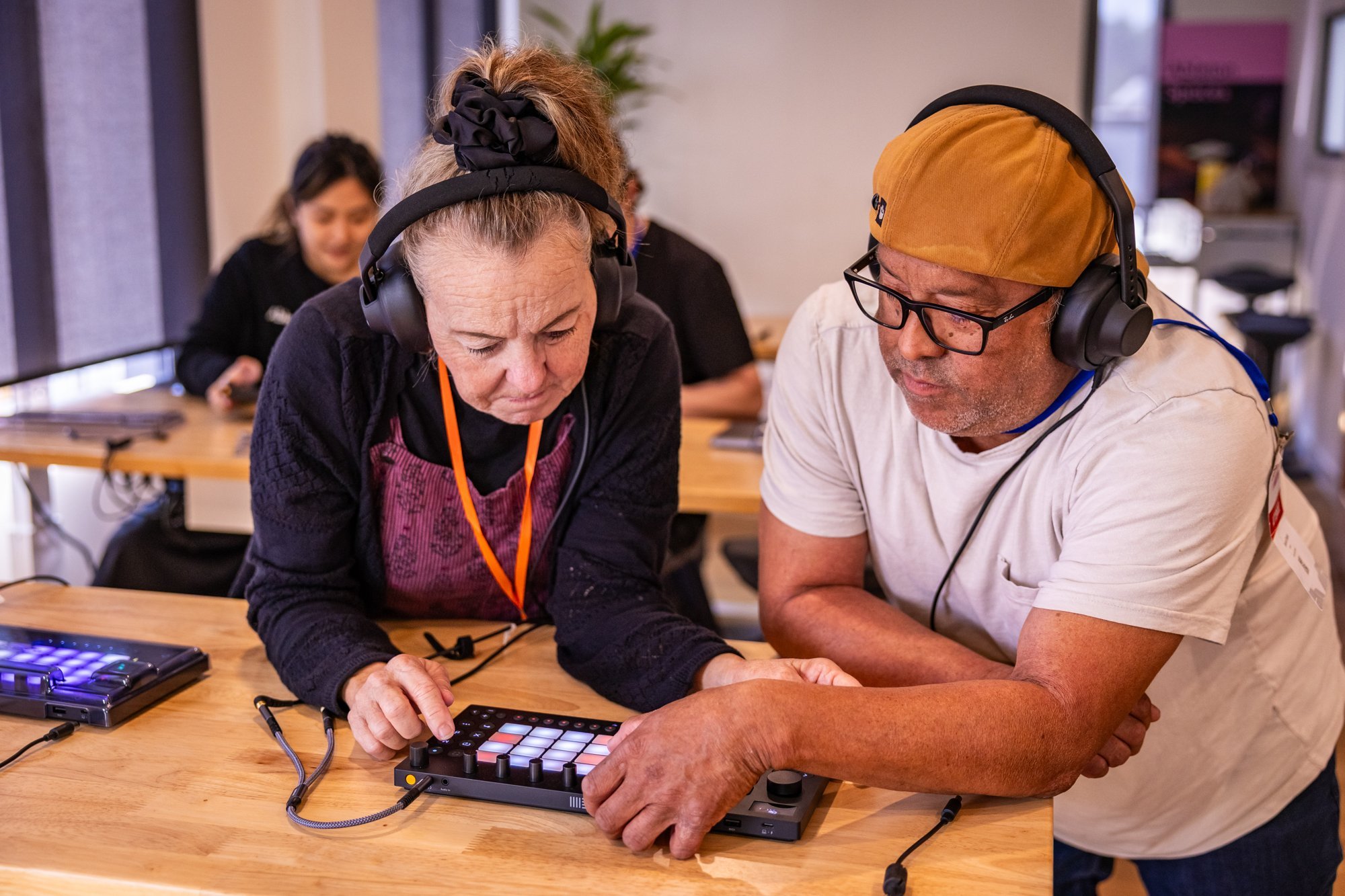 Two teachers work together on Ableton Move while preparing their performance