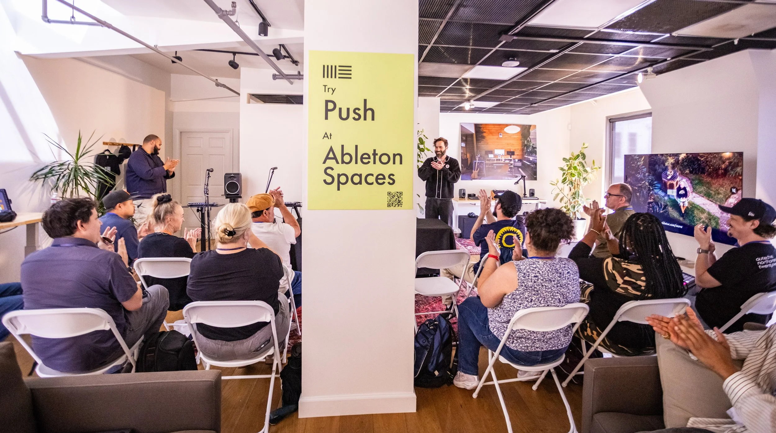 Teachers applaud during the listening party in the Ableton Studio at Ableton Spaces