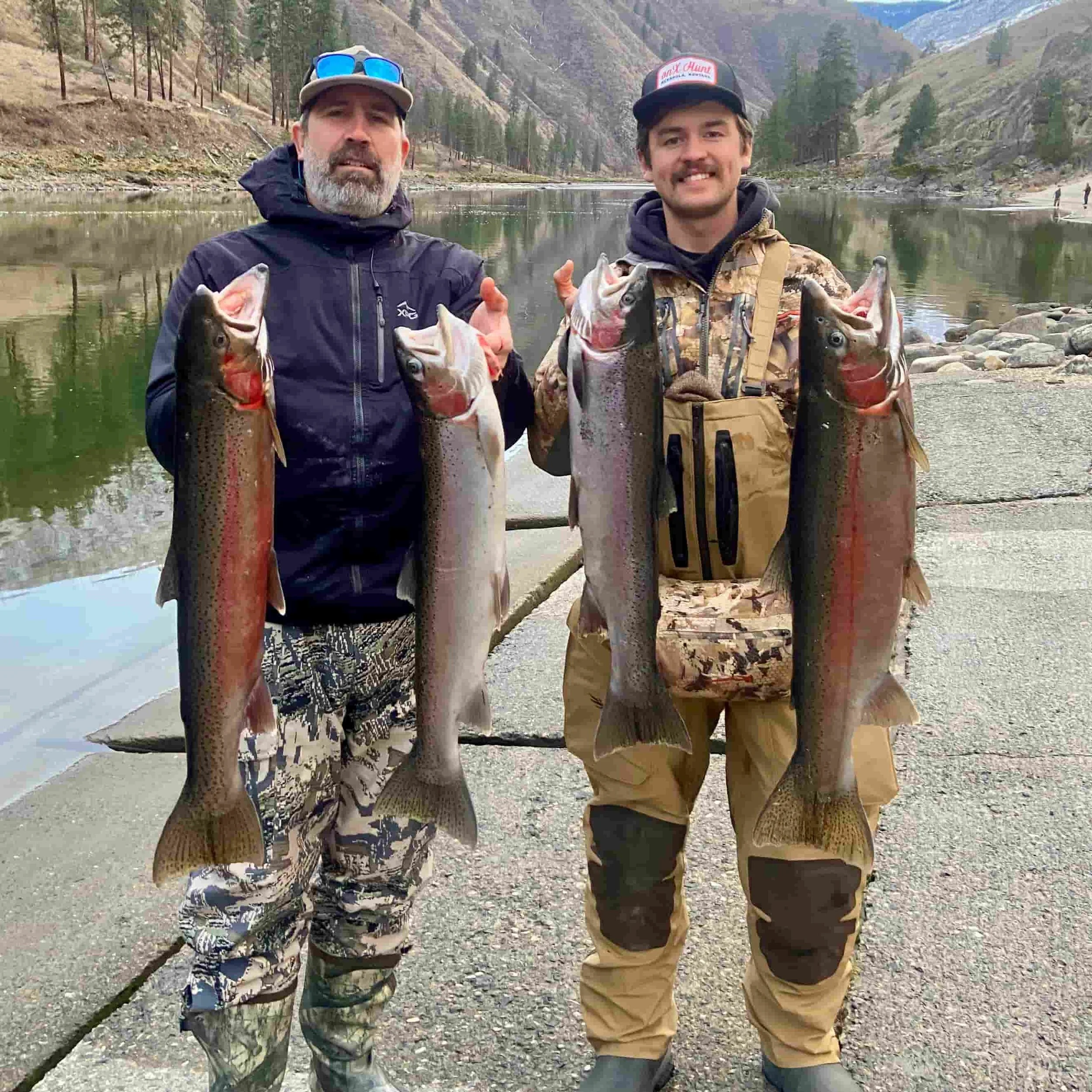 Happy clients holding a limit of hatchery steelhead