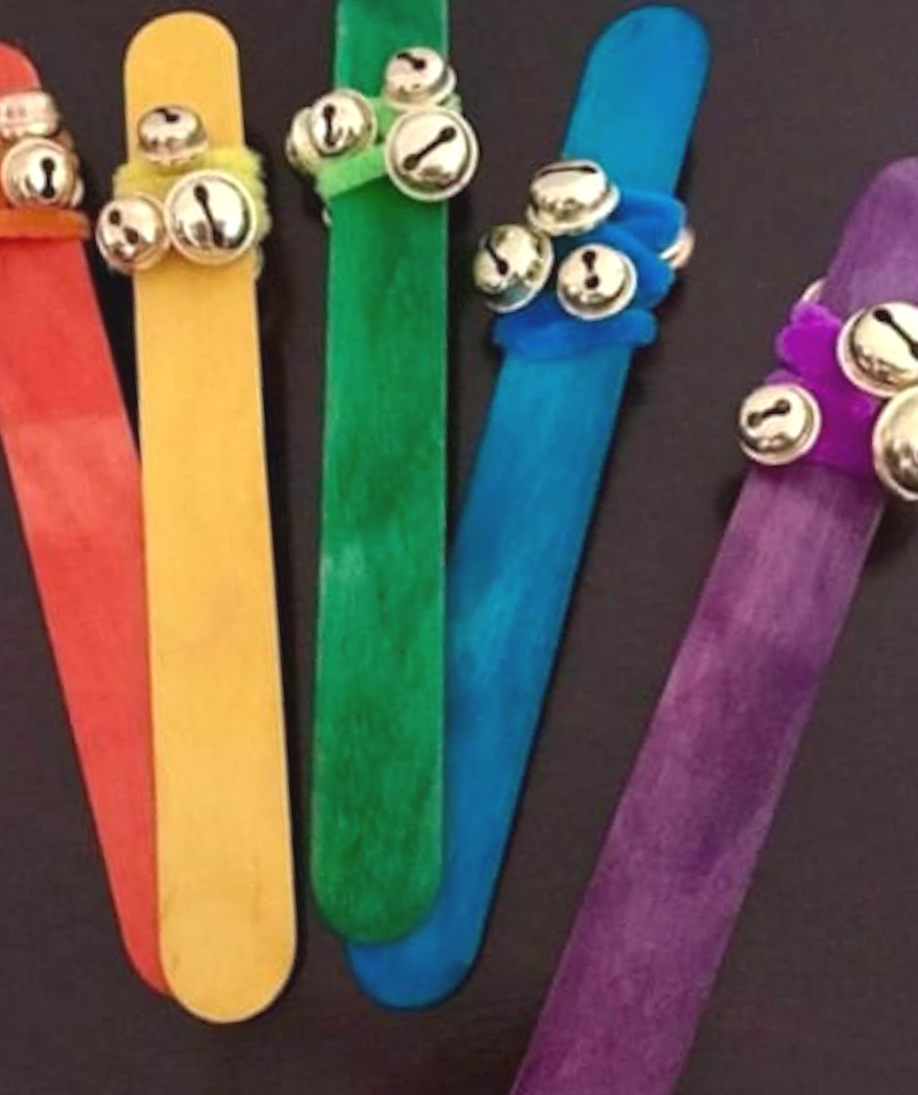 Colorful craft sticks arranged in fan shape with small visual icons attached, representing visual language, symbols, and visual thinking tools used in Visual Versa workshops