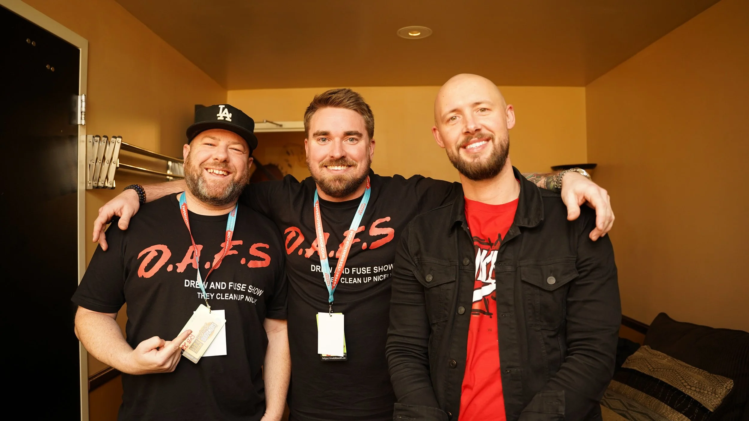 Djs Drew Pierce , Fuse, and DJ Scooter together in Las Vegas with their arms around each other's shoulders in a room.