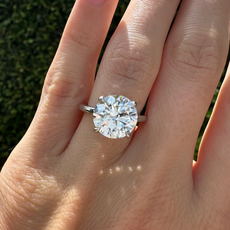 Round brilliant diamond engagement ring on a hand