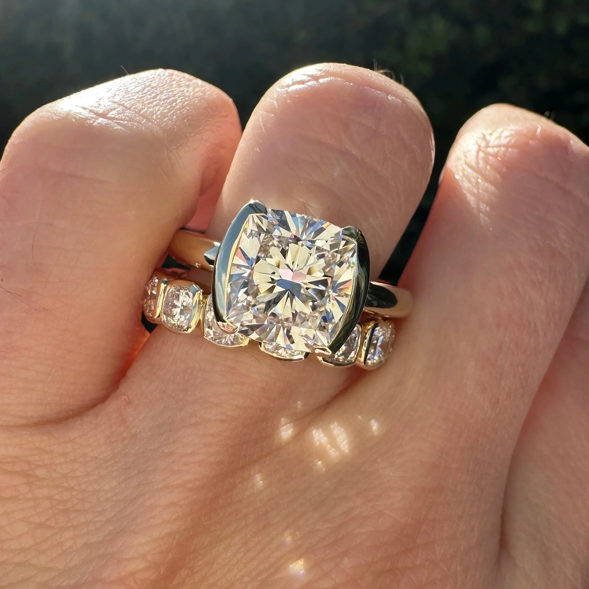 Cushion-cut diamond engagement ring stacked with a diamond wedding band