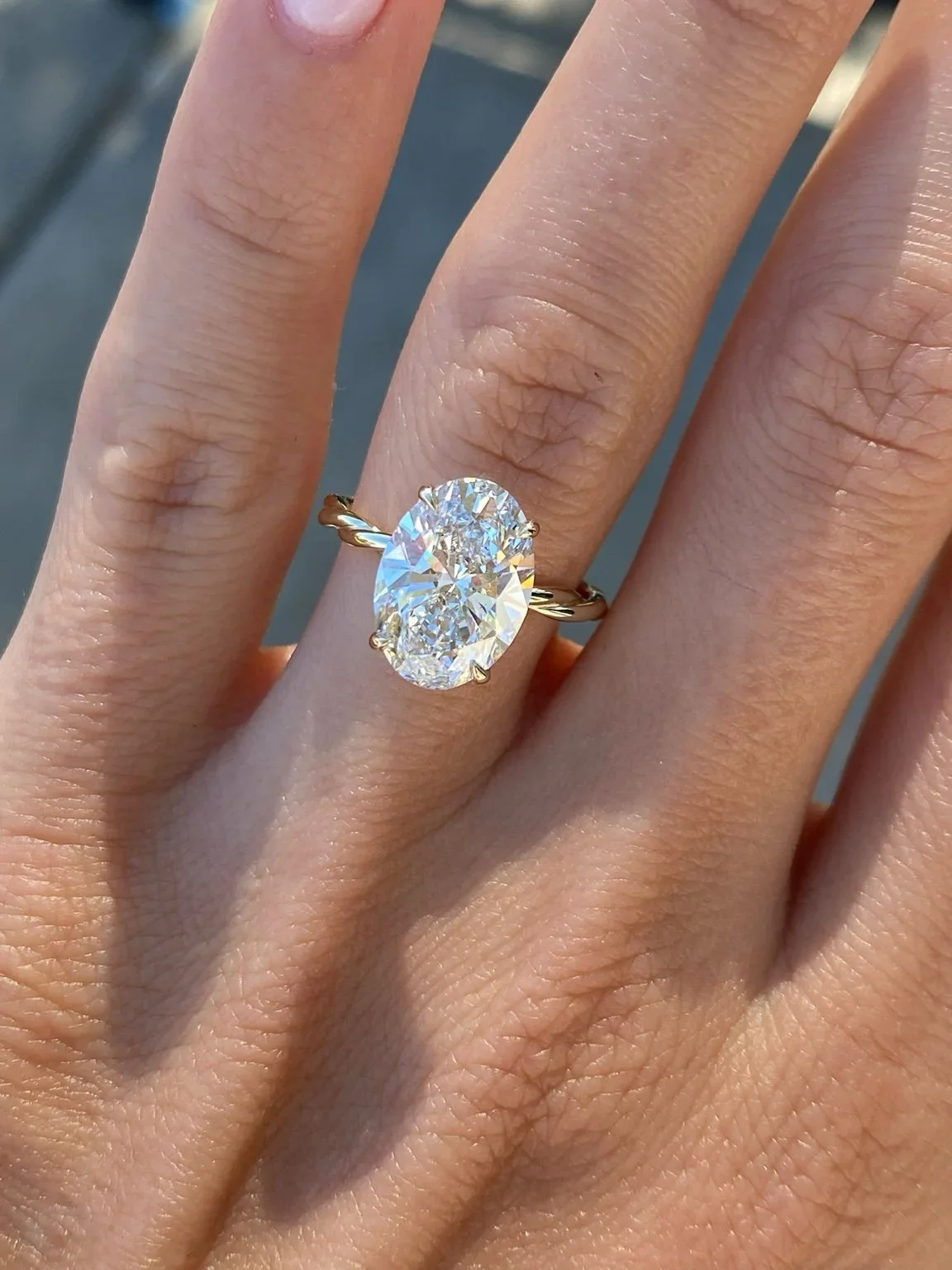 Oval diamond solitaire engagement ring on a twisted band