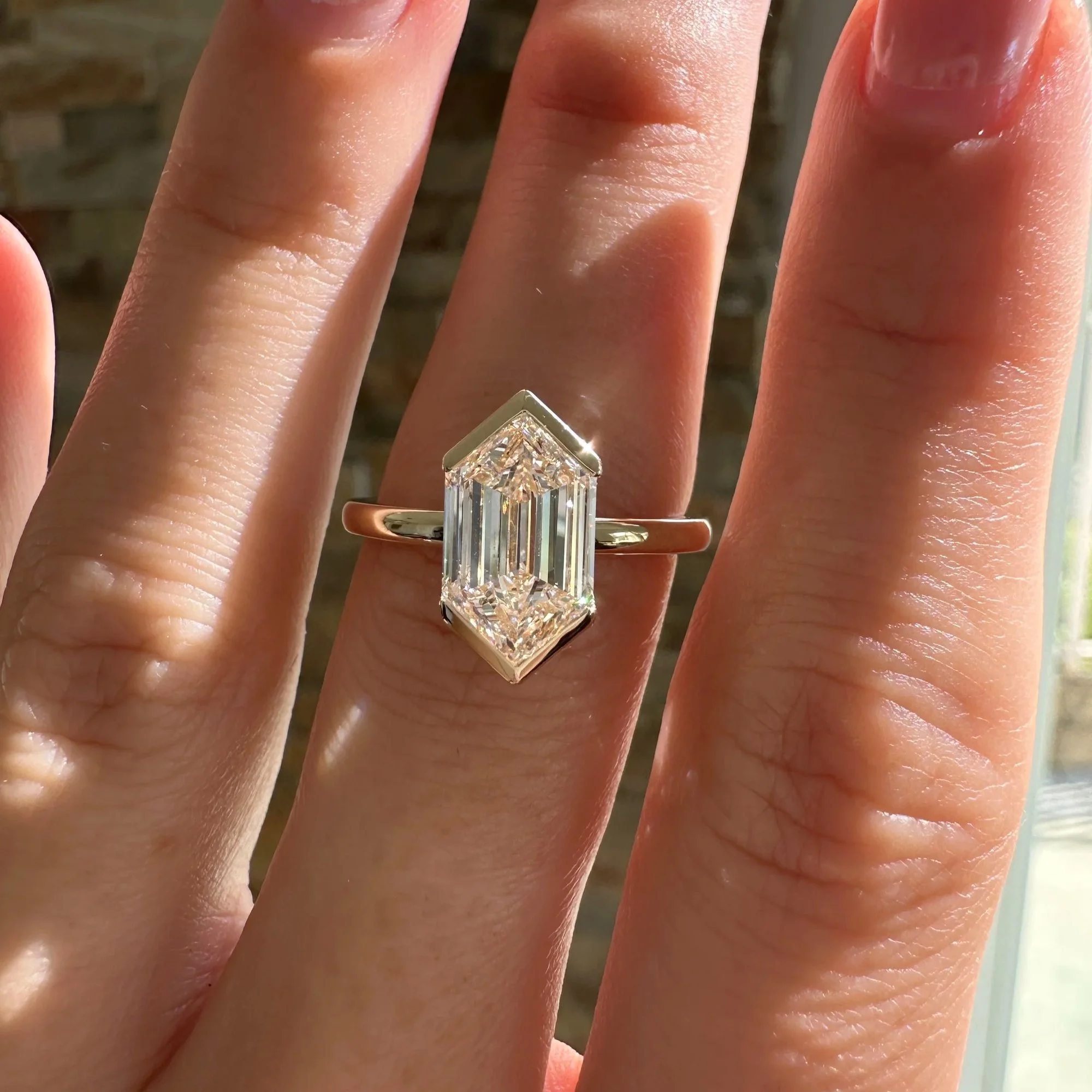 Elongated hexagon diamond solitaire engagement ring