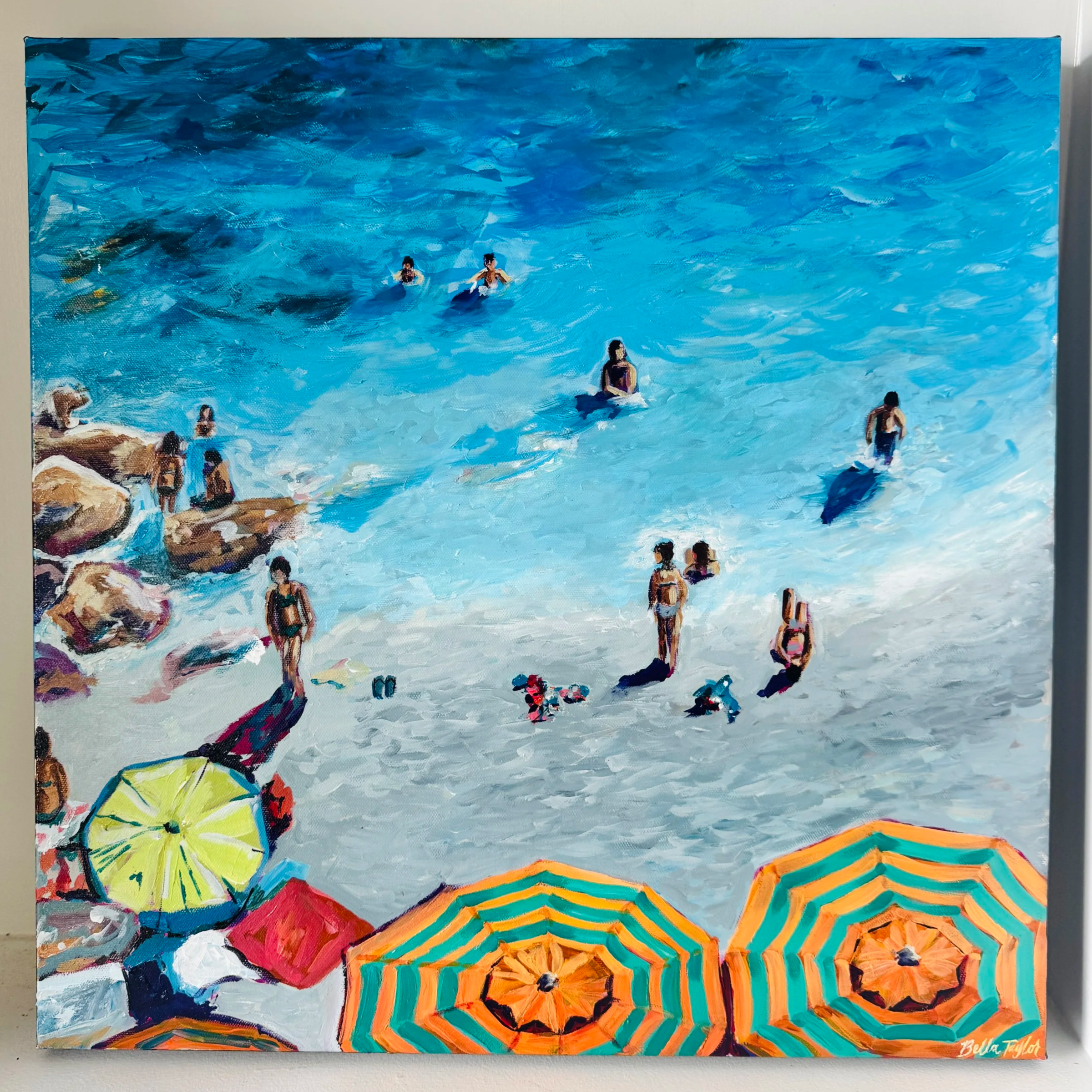 A colorful painting of a beach scene with people swimming in the ocean, umbrellas on the sand, and a vibrant sky.
