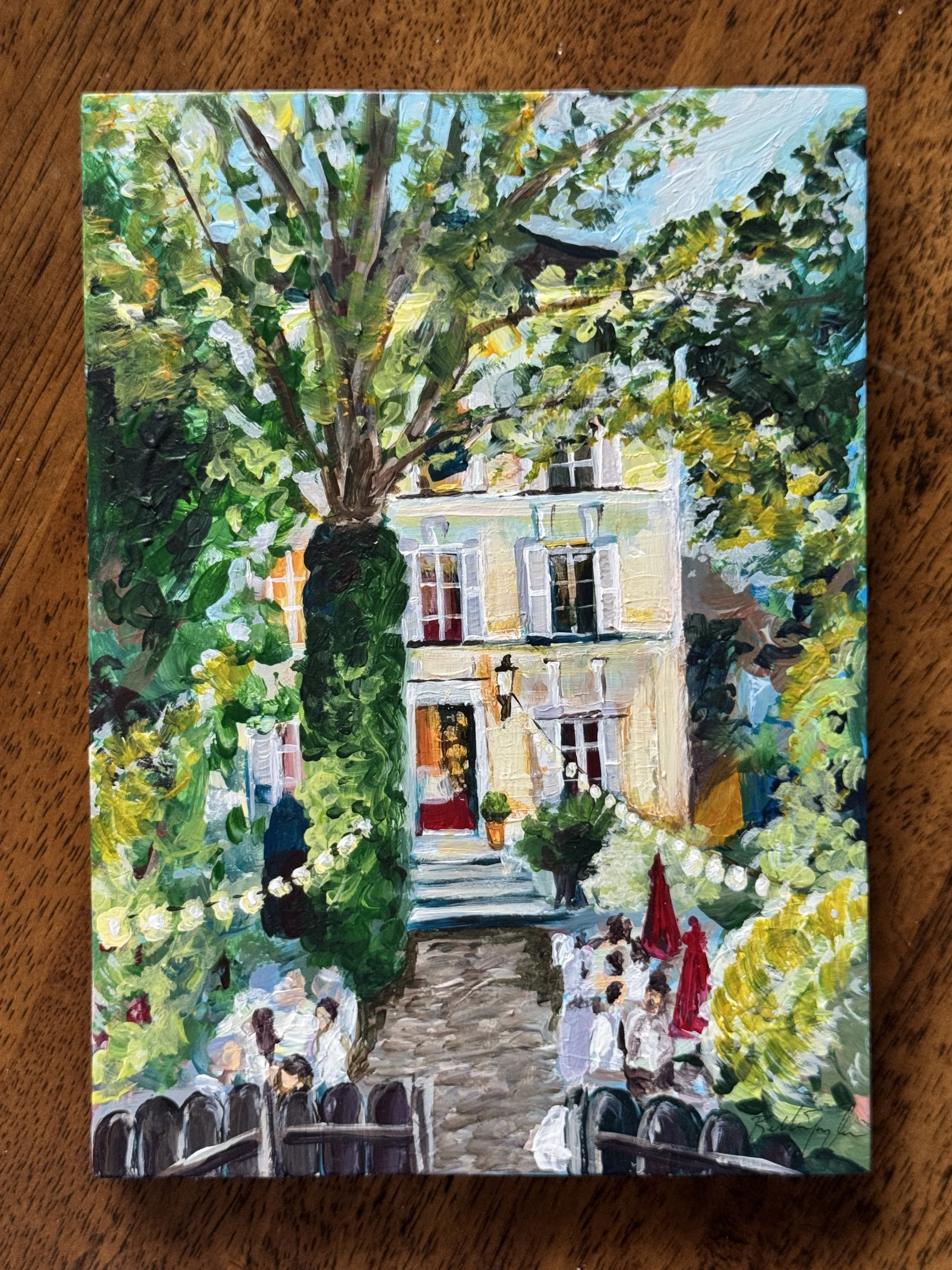 A colorful impressionistic painting of a tree-lined street with a building in the background and people sitting outside a cafe.