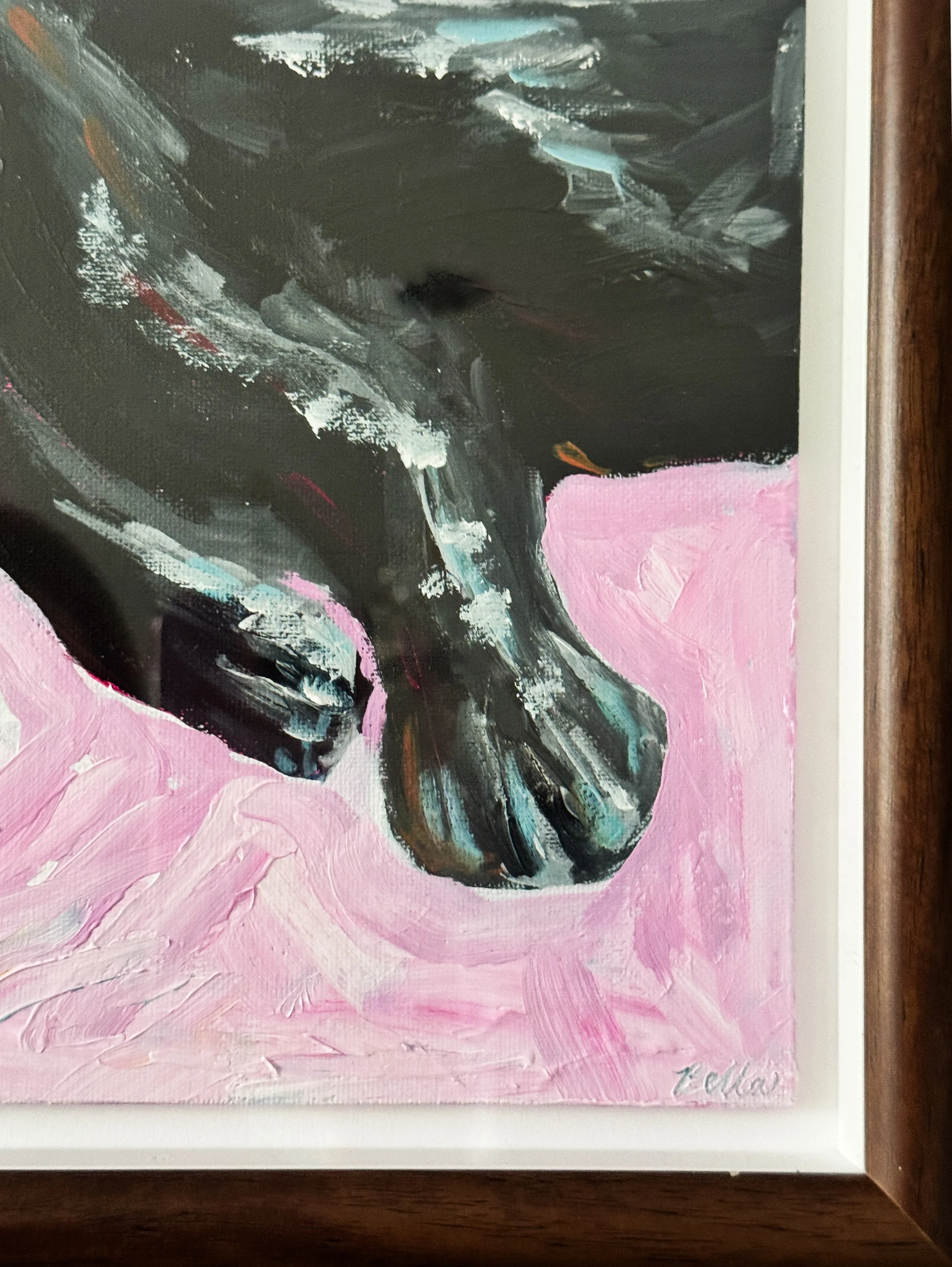 Painting of a black dog with hints of blue and white on a pink background, signed 'Bella' at the bottom right corner.