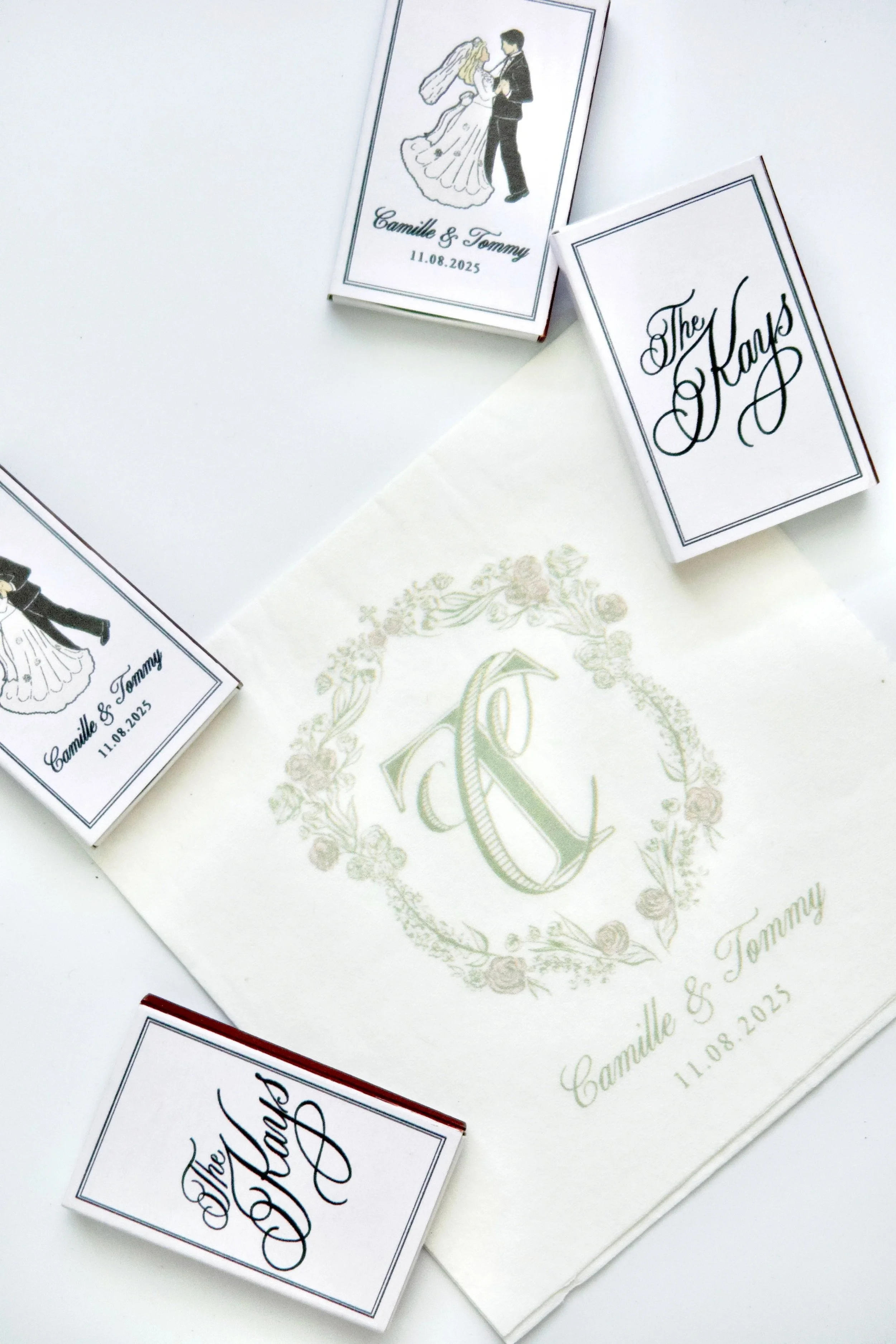 Wedding-themed matchbooks with illustrations of a bride and groom, and elegant text reading 'The Kays' and names 'Camille & Tommy' with wedding date '11.08.2025'.