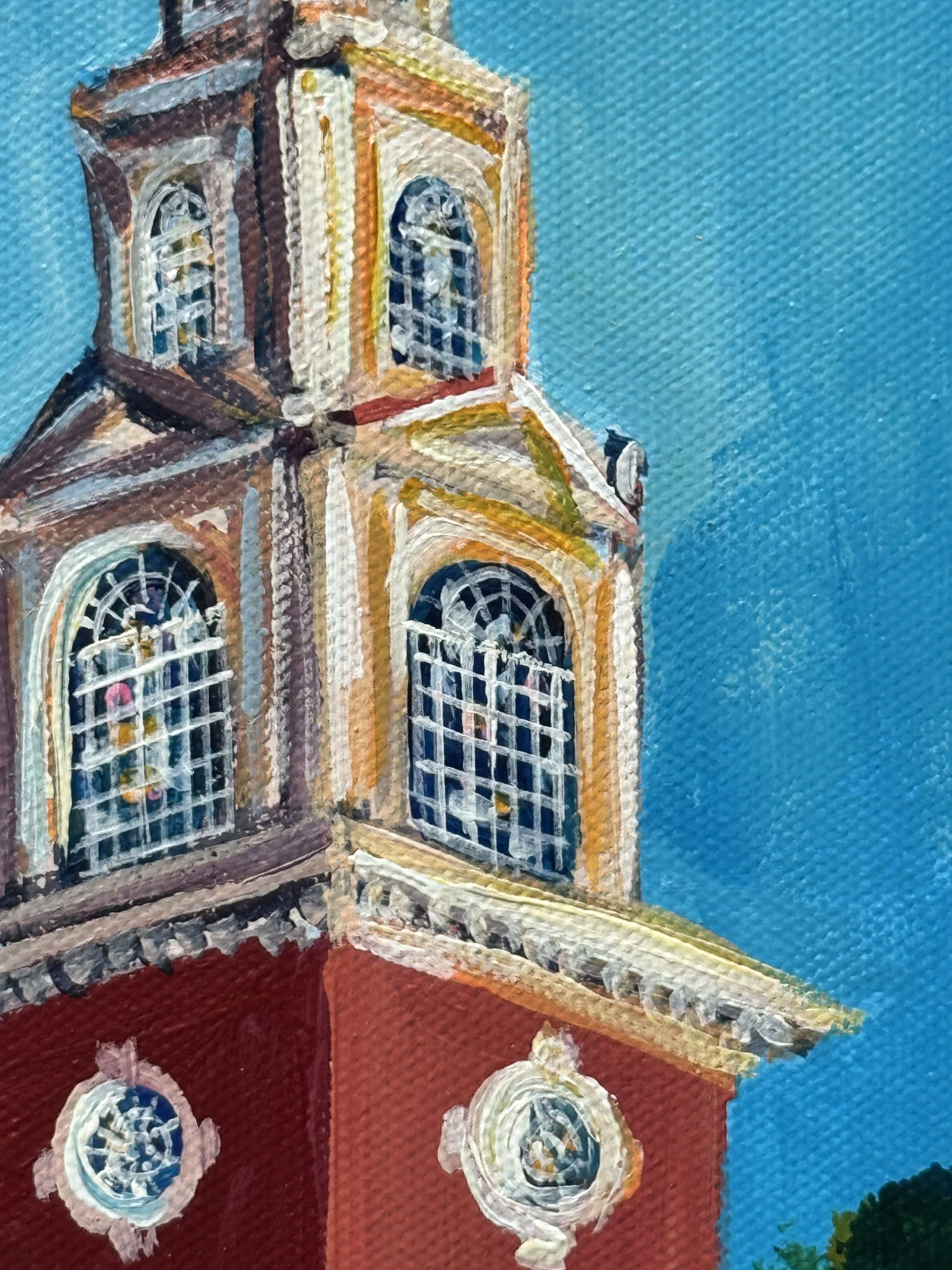 Close-up of a colorful acrylic painting of a historic church with stained glass windows against a vibrant blue sky.