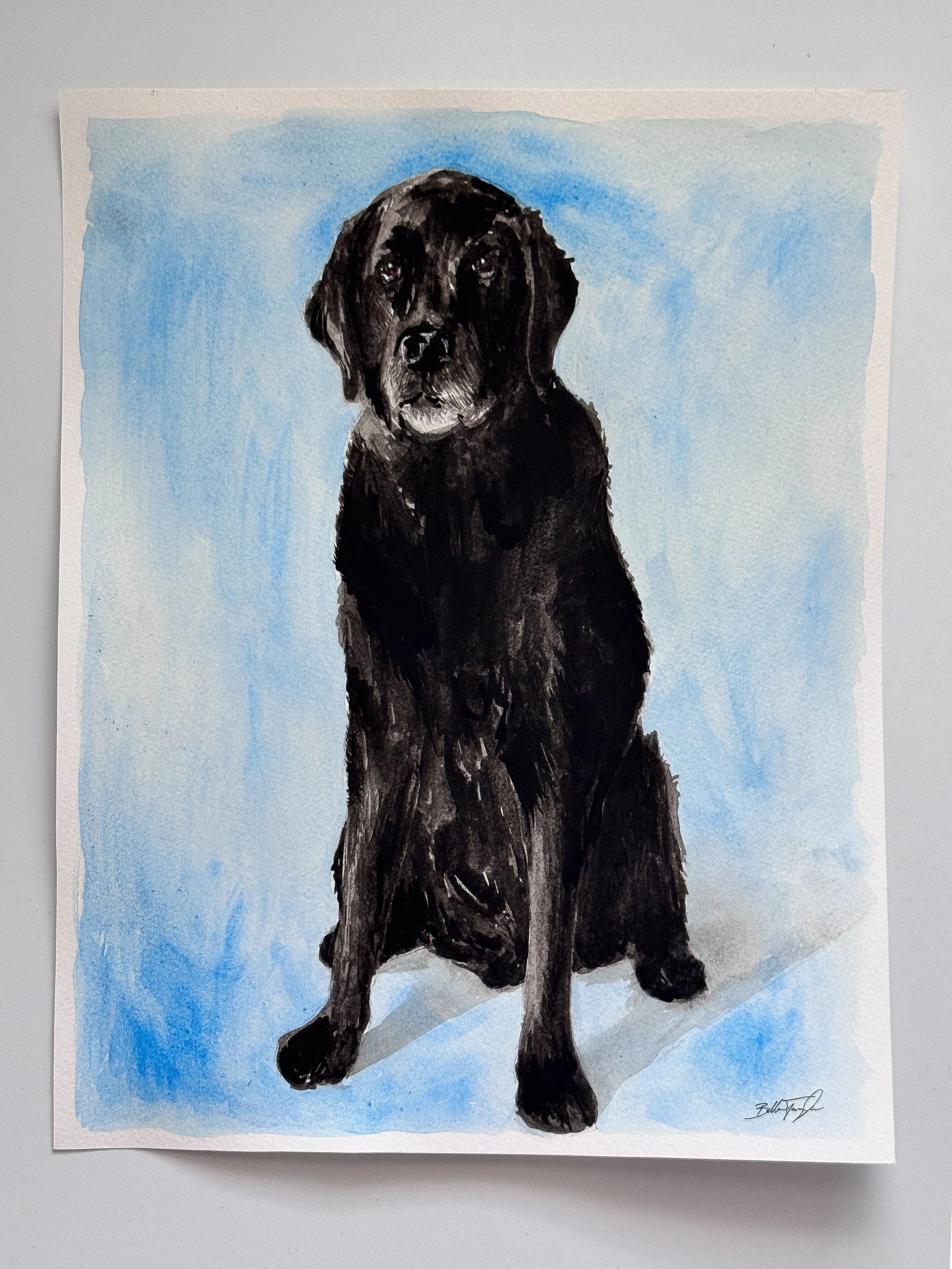 Watercolor painting of a black Labrador retriever sitting against a blue sky background.